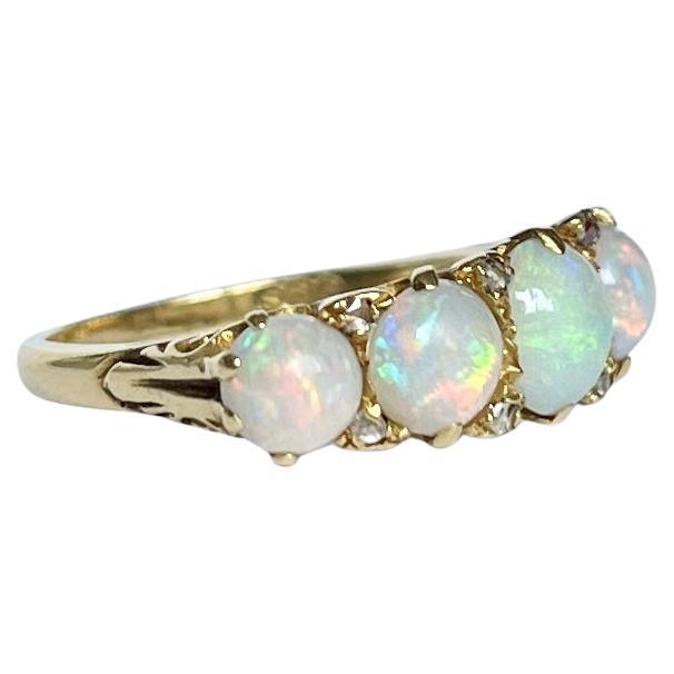 The opals in this ring are gorgeous and throw some great colours. They are set flush within the 18ct gold claws, there are also diamond points and a very ornate gallery. Fully hallmarked London 1969. 

Ring Size: M 1/2 or 6 1/2 
Face Width: 7.5mm