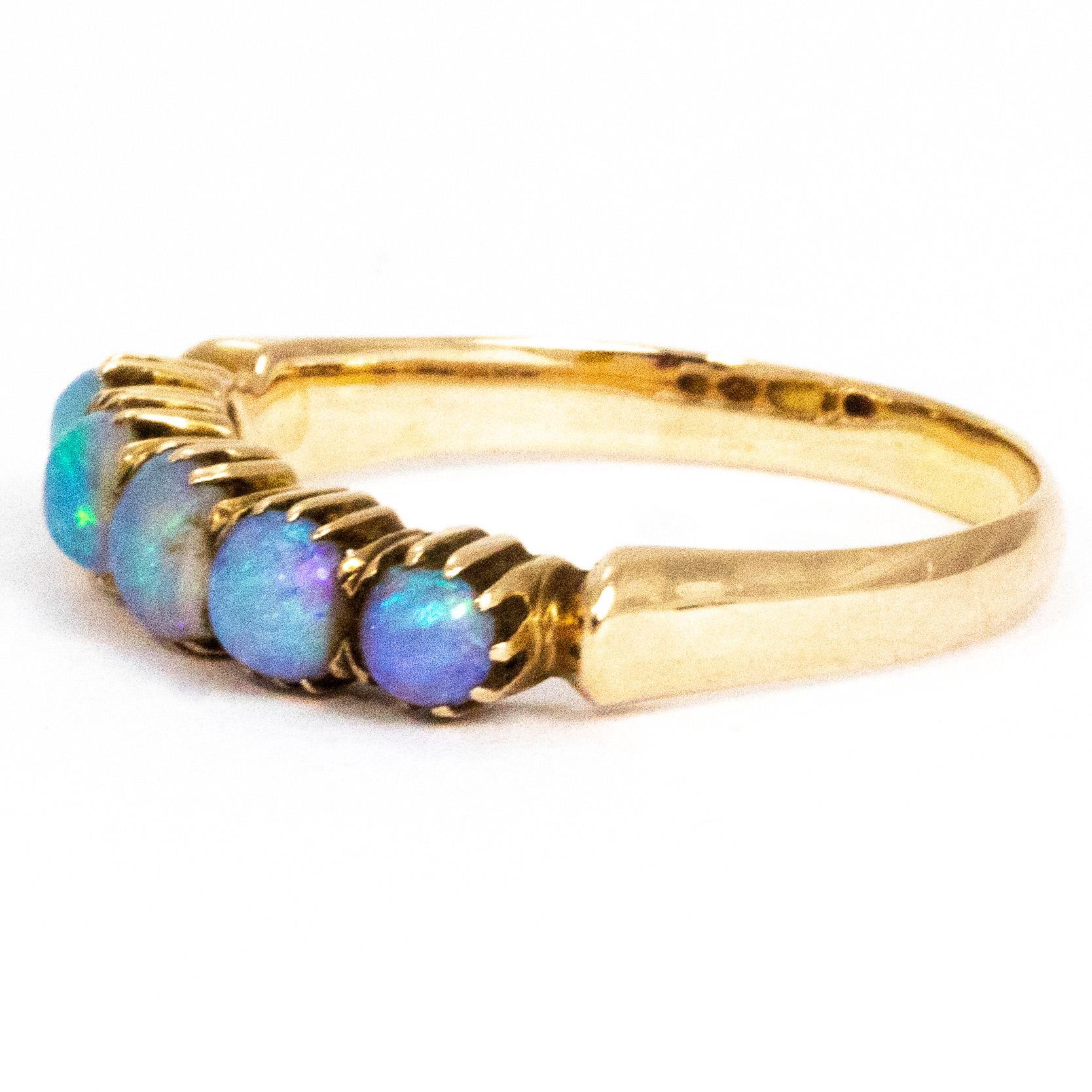 The opals in this five stone band are absolutely magical. They have a gorgeous strong blue hue with flecks of purple, green an so many other colours. The stones are encased in crimped 9ct gold. The centre stone measures 30pts and the outer stones