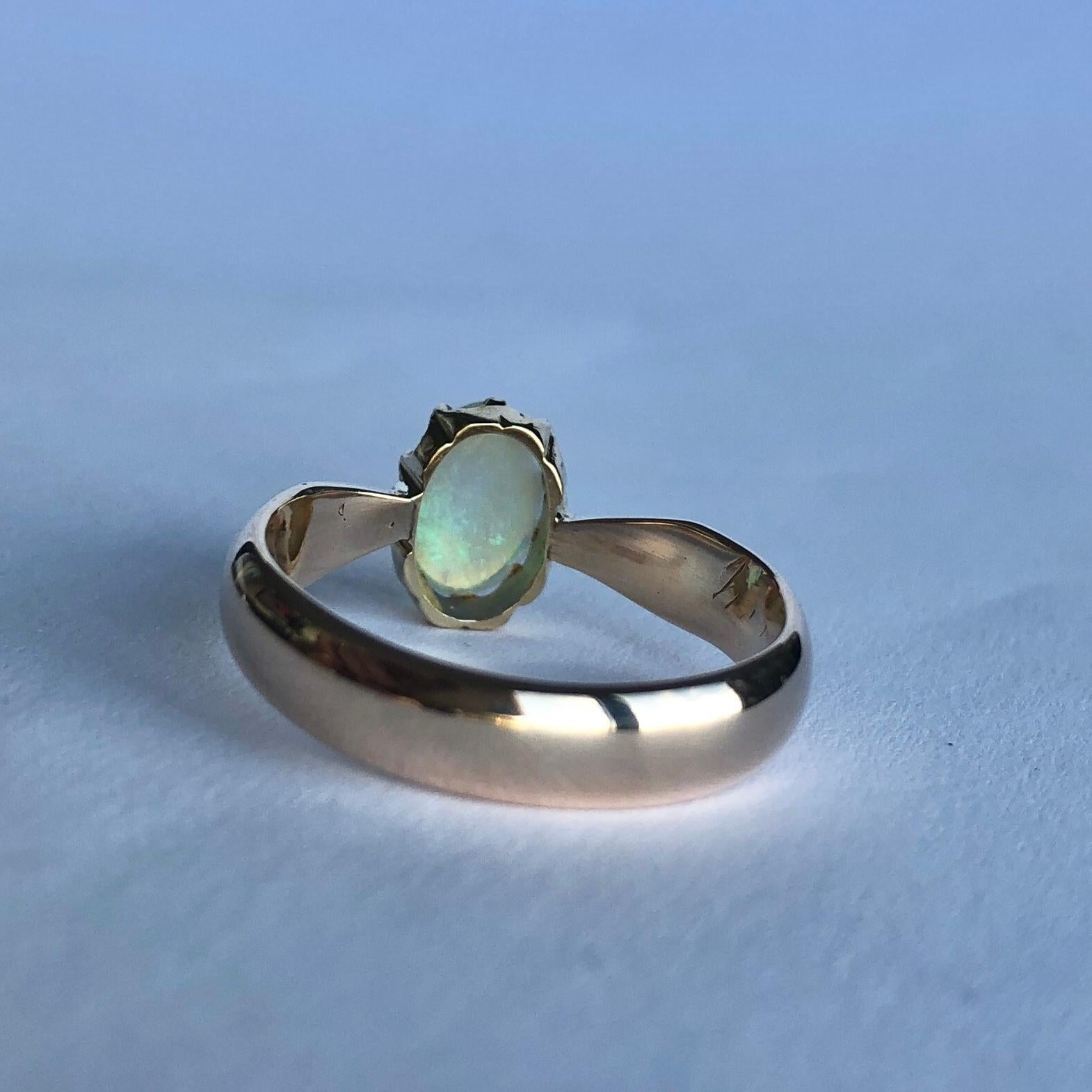 The opal set up high in a crown style setting is so glossy and throws so much colour! There is an inscription on the inside of the band which is rather worn so the letters 'H P R' is all that can be read. Modelled in 9ct gold. 

Ring Size: M or 6