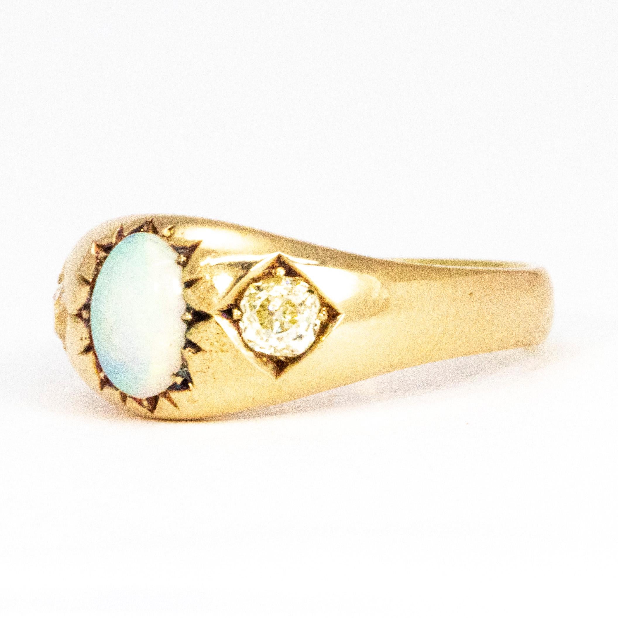 This gorgeous gypsy style ring holds an opal in a star setting at the centre and either side there are two 15pt old mine cut diamonds held in square settings. Modelled in 15ct gold. 

Ring Size: P 7 1/2 
Band Width: 8.5mm