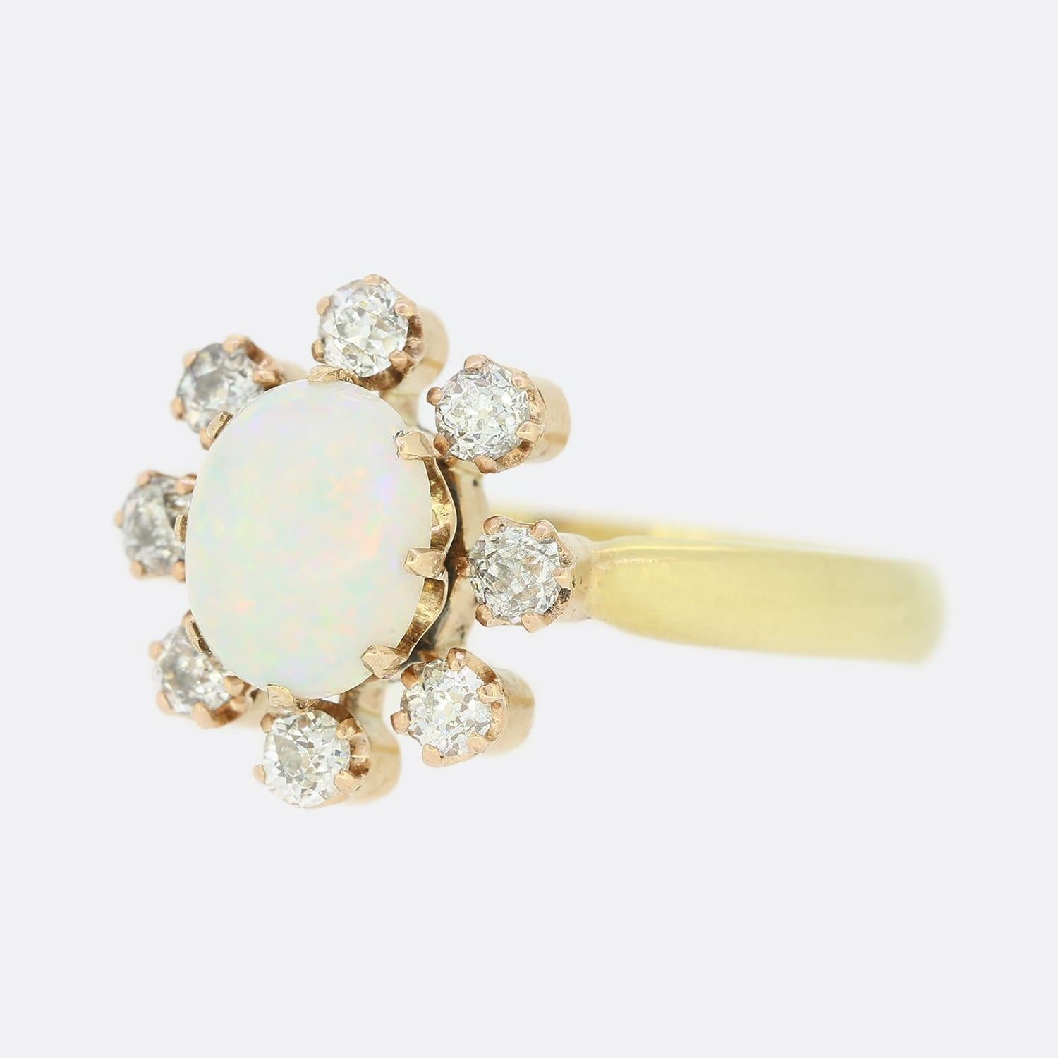 This vintage 18ct yellow gold ring plays host to an oval opal surrounded by 8 old cut diamonds. The opal has a wonderful play of colour and is a highly desirable tone.
The ring was masterfully converted from a Victorian stick pin by the antique