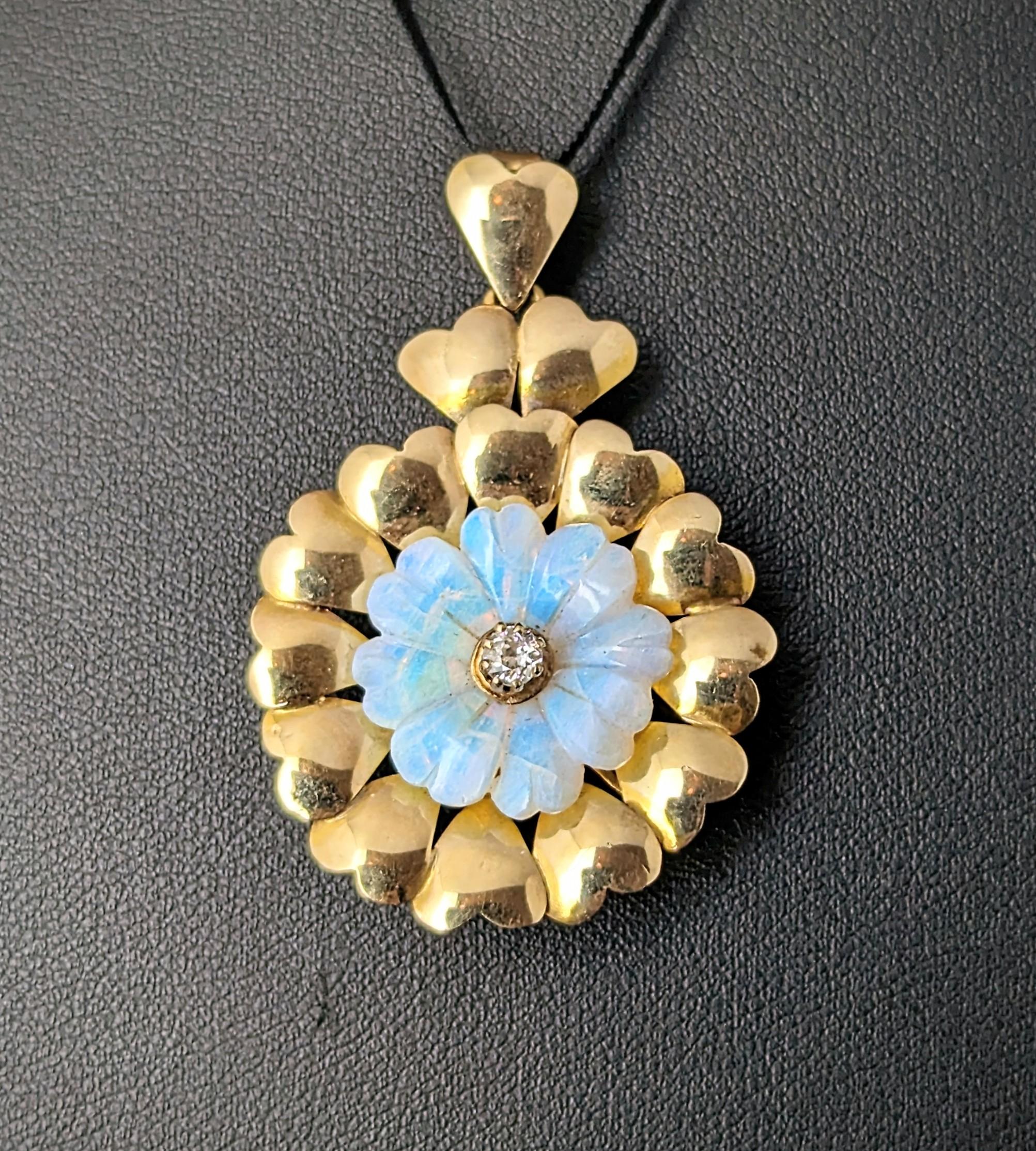 This beautiful vintage Opal and Diamond flower pendant is really something else!

A wonderfully pretty design the flower petals made from carefully hand carved Opal in a wonderful array of colours, each petal is shaped like a heart.

To the centre