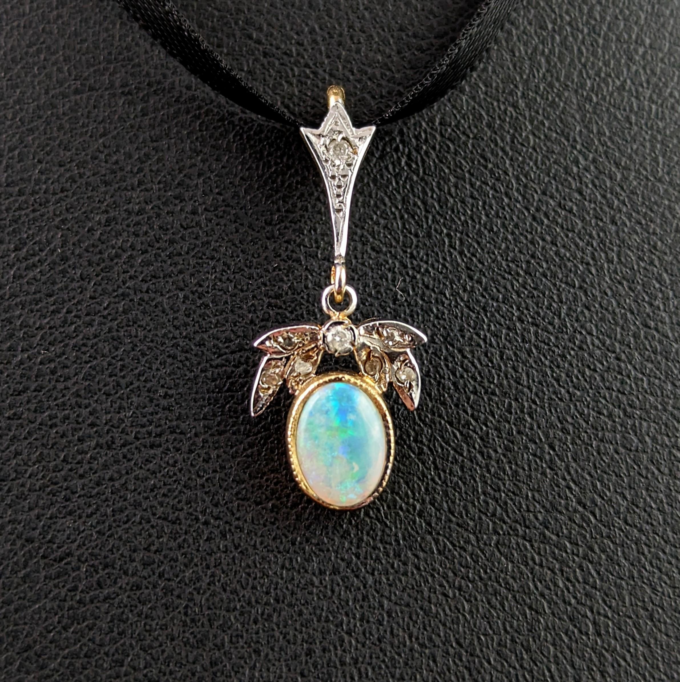 A pretty and dainty vintage Opal and Diamond pendant.

It is crafted from 9ct yellow gold with a white gold front and designed in the Art Deco style.

The bale is set with a small diamond and suspended from there is a tiny drop designed with diamond