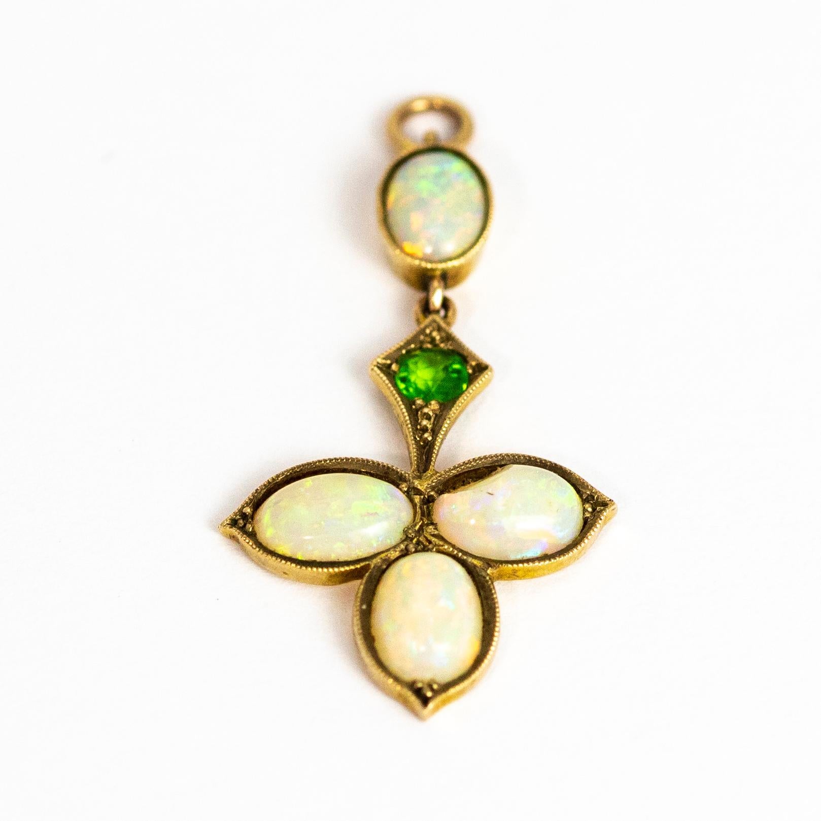 This fabulous pendant holds a total of four opals which shimmer all different colours. Set in a three leaf style pendant and also holds a green garnet in a kite shaped setting. Modelled in yellow Gold.

Drop: 35mm
Width: 17mm
*please note, there is
