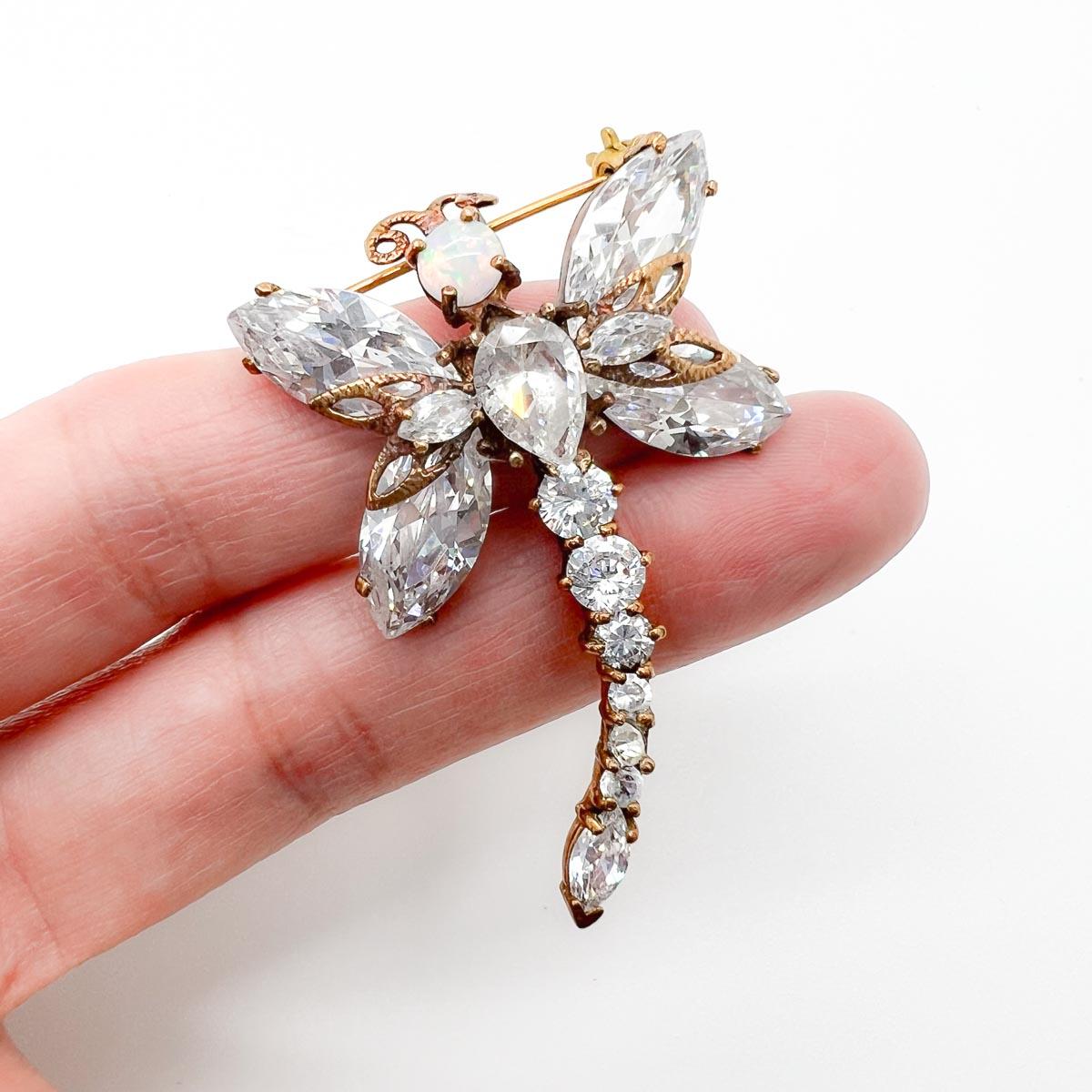 A Vintage Opal Crystal Dragonfly Brooch. Set with delightful crystals in fancy cut shapes and finished with a fiery opal for the head. Said to symbolise change and transformation this would make a beautiful gift or self gift if you are ringing the