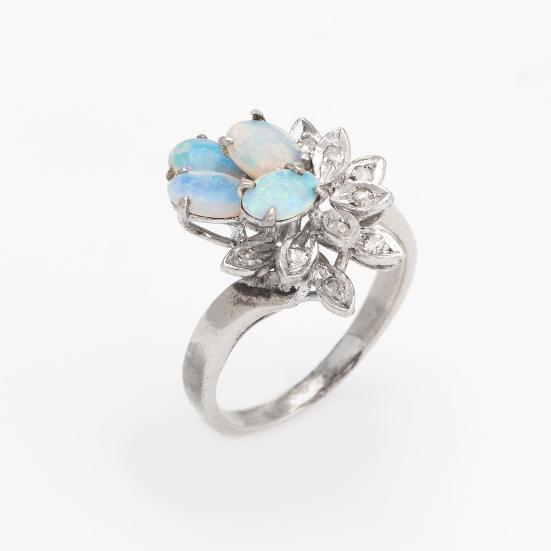 Finely detailed vintage opal & diamond cocktail ring (circa 1950s to 1960s), crafted in 10 karat white gold. 

Natural opals measure 6mm x 4mm each, estimated at 0.40 carats each (1.60 carats total estimated weight), accented 10 estimated 0.01 carat