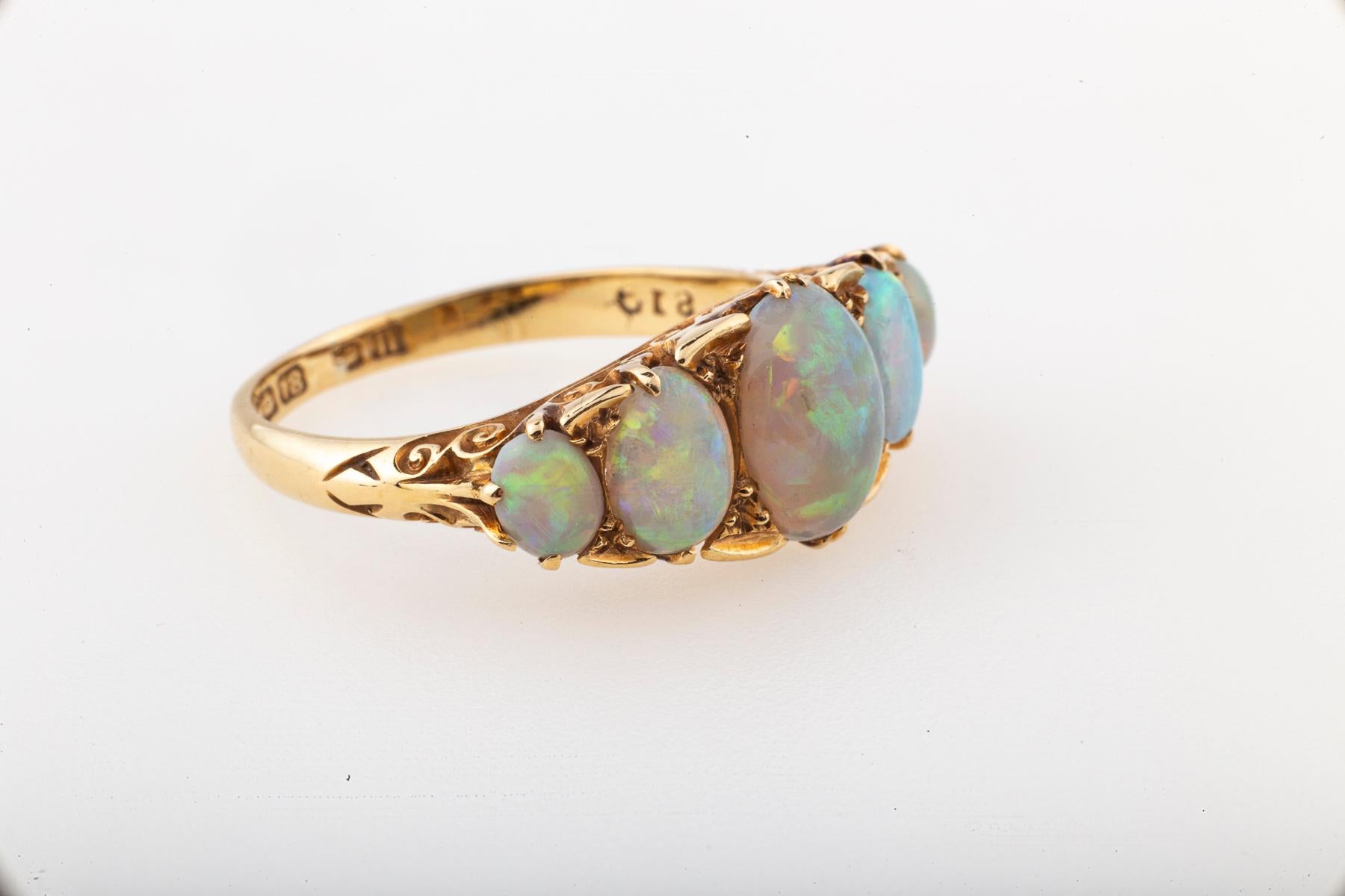 Opal is a treasure of nature flashing a kaleidoscope of colors in each stone. Daylight sets off the Blues, green, yellows and multiple shades of pink vary in each stone as all stones are singular. These five gems are well matched and set in 9kt gold
