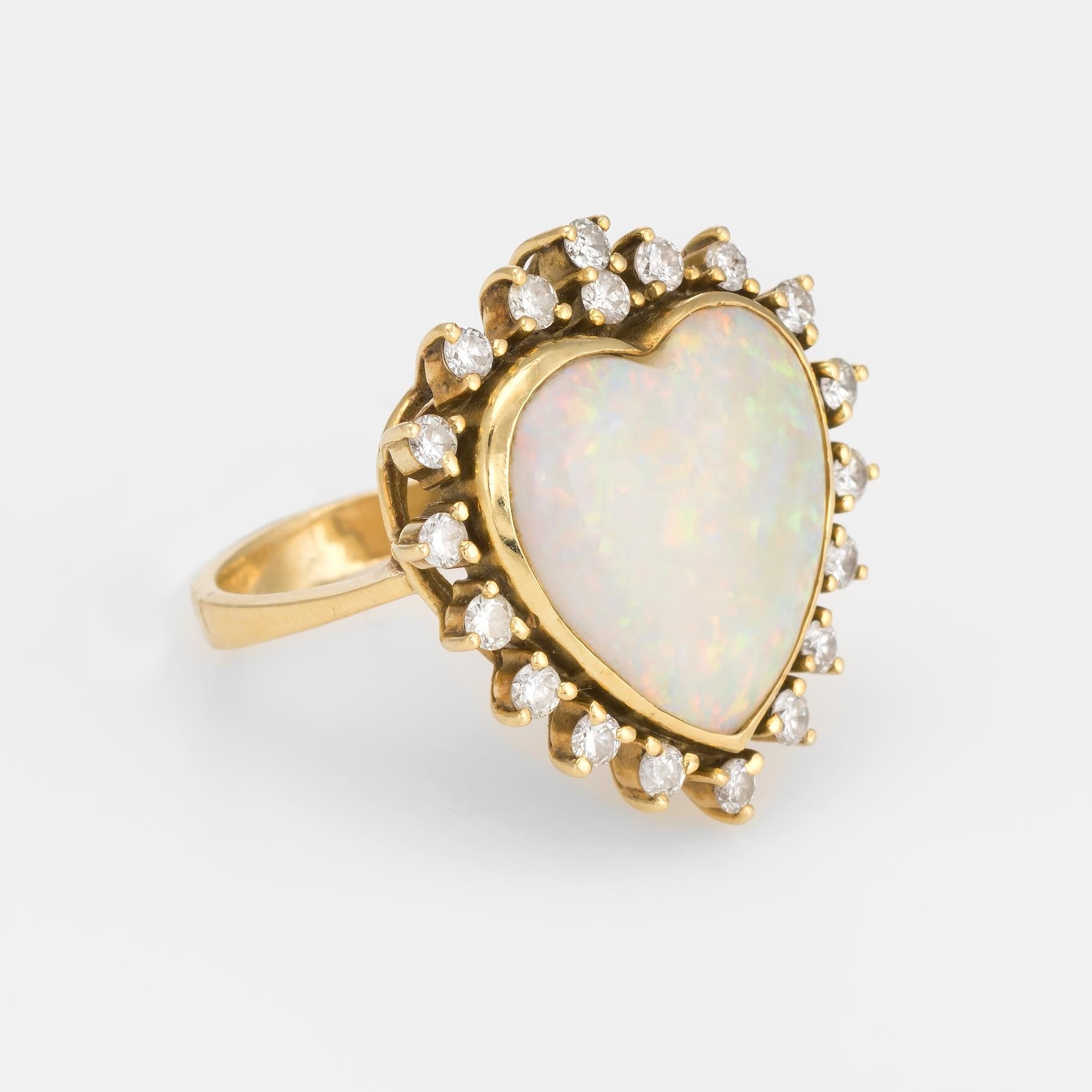 Finely detailed vintage opal & diamond heart cocktail ring (circa 1970s to 1980s), crafted in 18 karat yellow gold. 

Heart cut natural opal measures 15mm, accented with 19 estimated 0.03 carat round brilliant cut diamonds. The total diamond weight