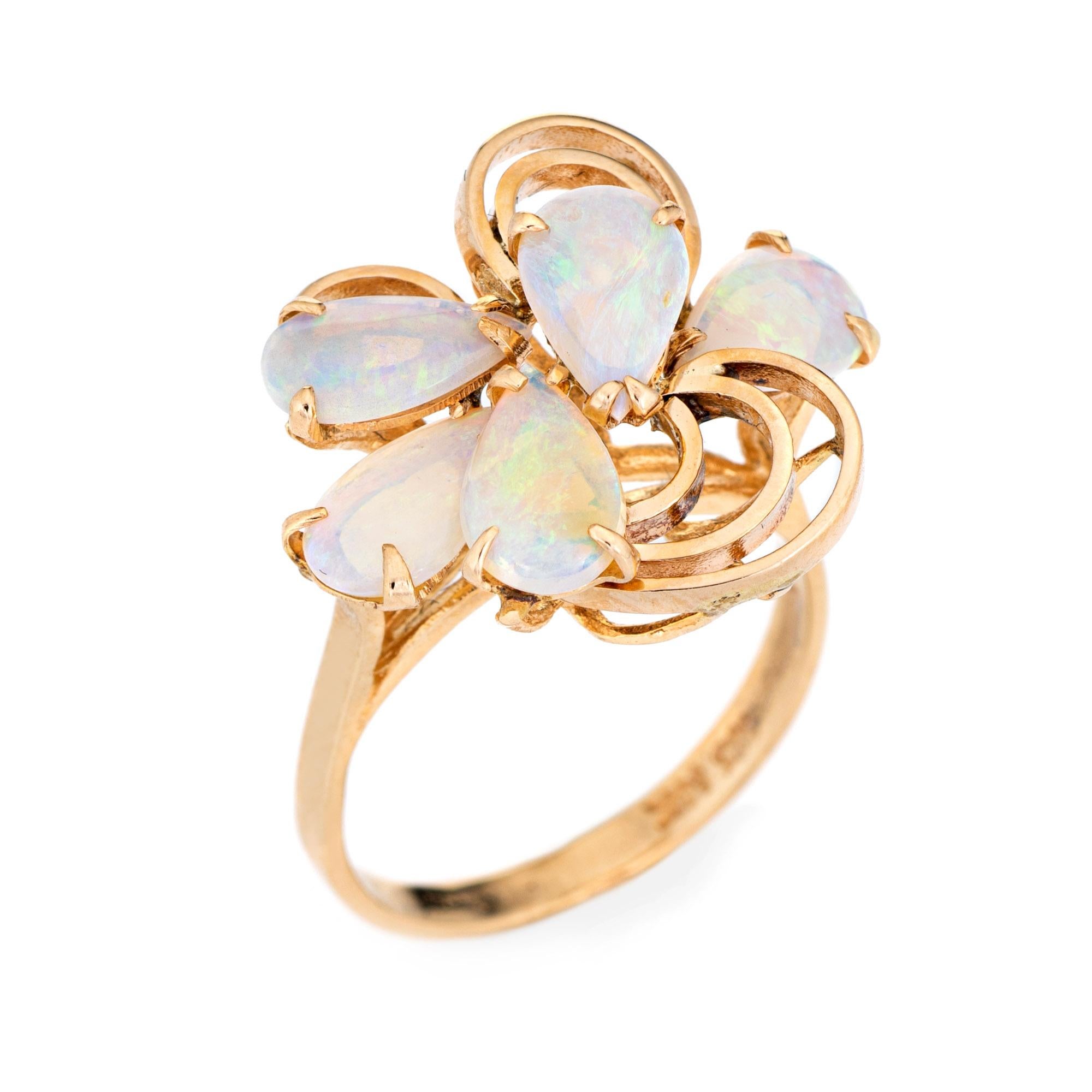 Stylish vintage opal ring (circa 1970s) crafted in 14 karat yellow gold. 

Five cabochon cut teardrop shaped opals measure 8mm x 5mm (estimated at 0.50 carats each - 2.50 carats total estimated weight). The opals are in very good condition and free