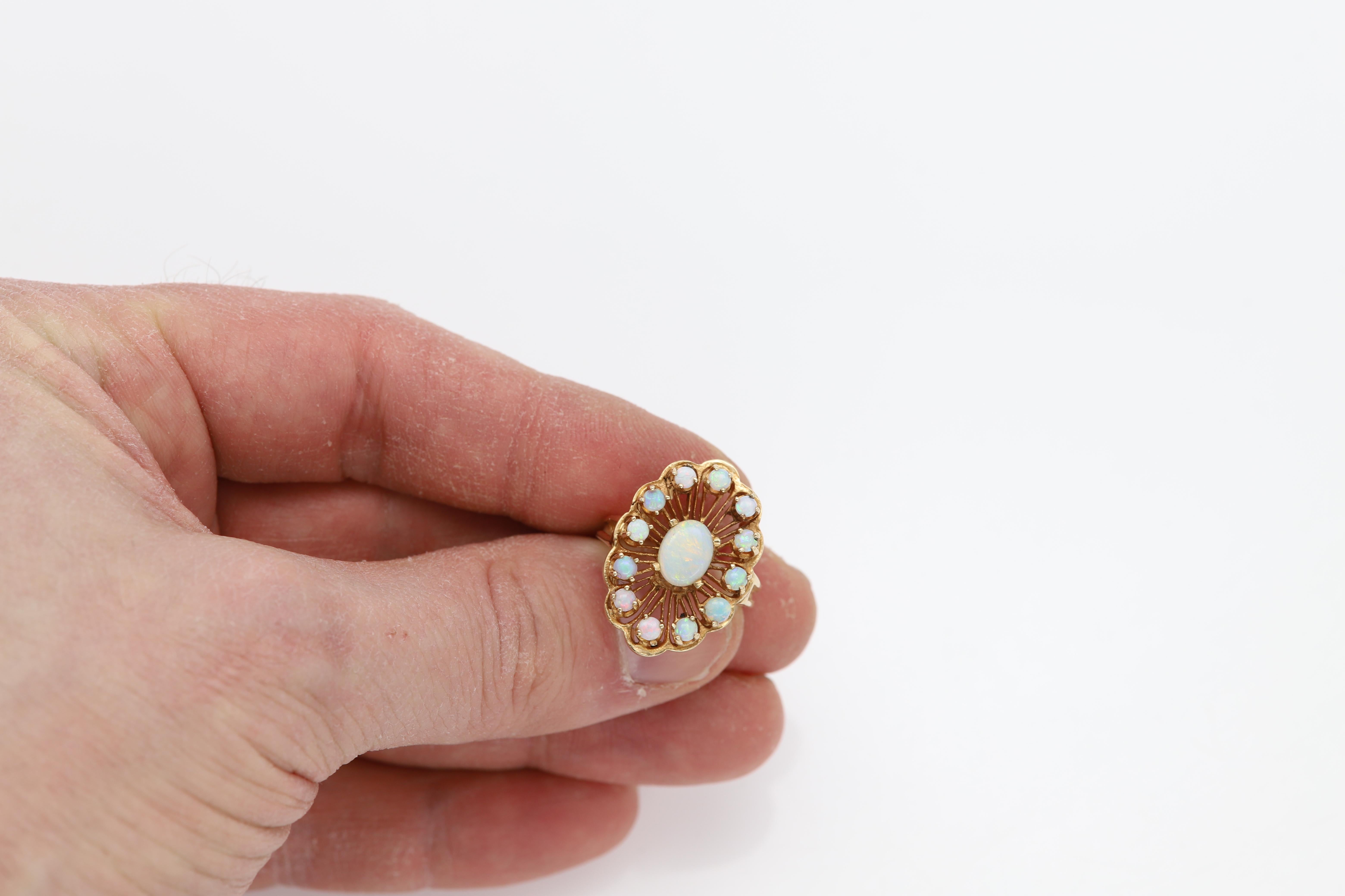 Vintage Ethiopian Opal Ring
Authentic Hand made
Natural Stones
Nice color and brilliance.
14k Yellow Gold approx 7.50 grams
Area design size approx 24 x 17 mm
Center Opal size 8x6mm
Finger size 6.5 (resizable)
circa 1950's
+Gift Box
+