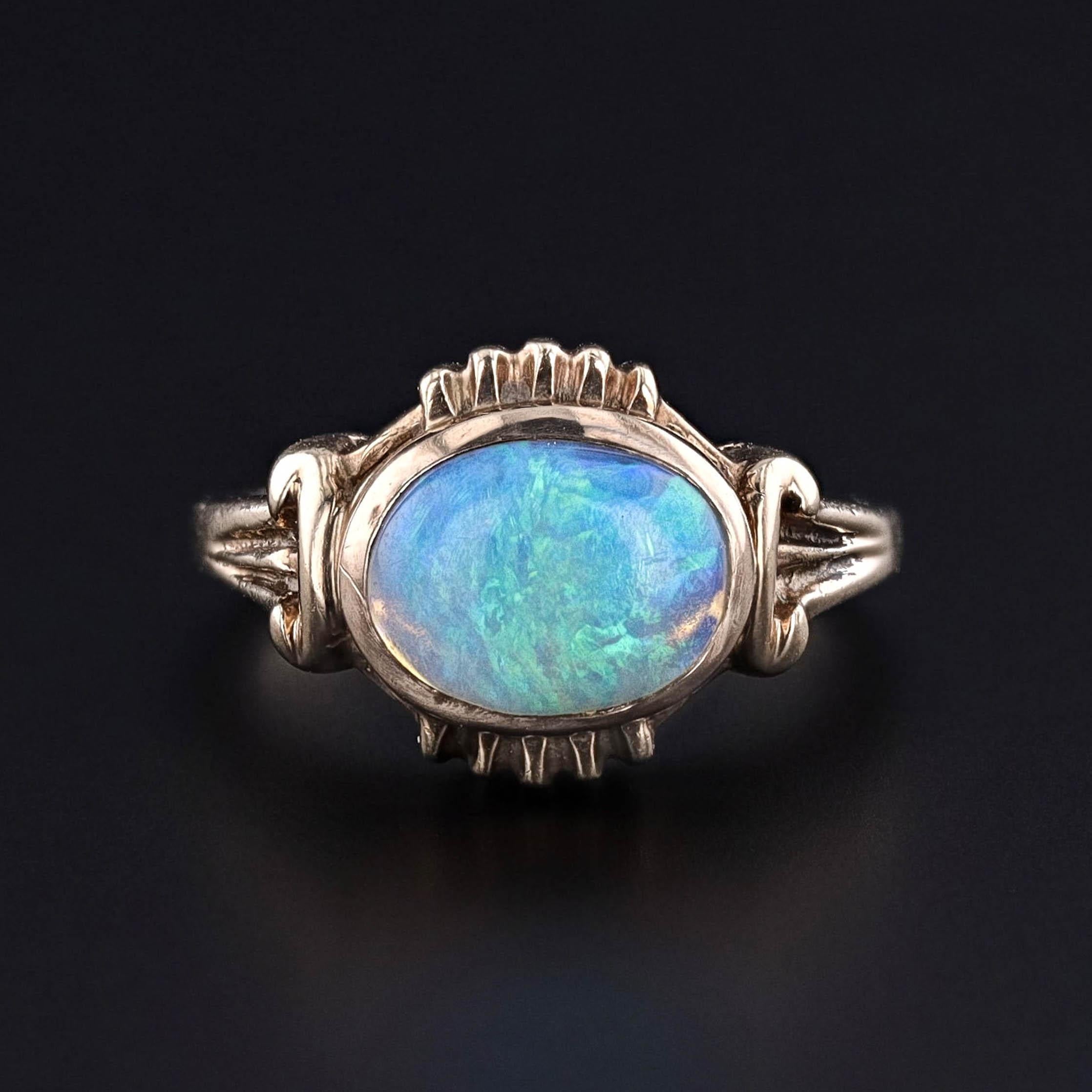 Vintage Opal Ring: This vintage ring (circa 1930) showcases a captivating opal cabochon with a rainbow hue, set in 10k gold.

The ring is a size 7.5 and can be resized to fit your needs. It is in excellent condition, ready to be worn and