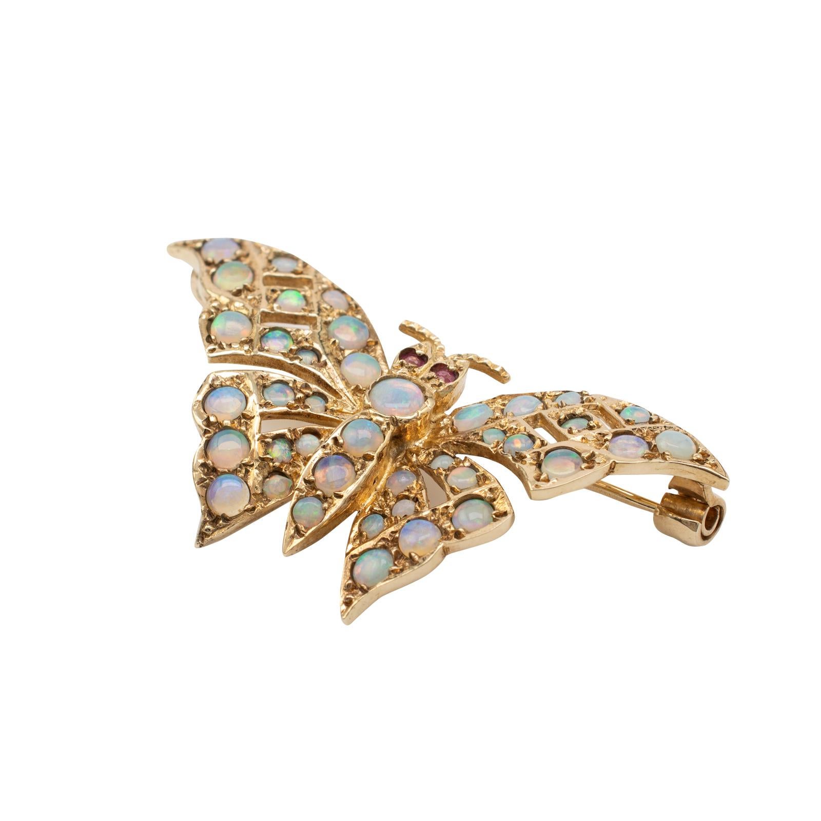 This beautiful vintage gold butterfly brooch, decorated with natural opals is hallmarked London 1985.

The butterfly is realistically sized and looks great adorned into a jacket lapel. The open pierce work gold is ornamented with various sized
