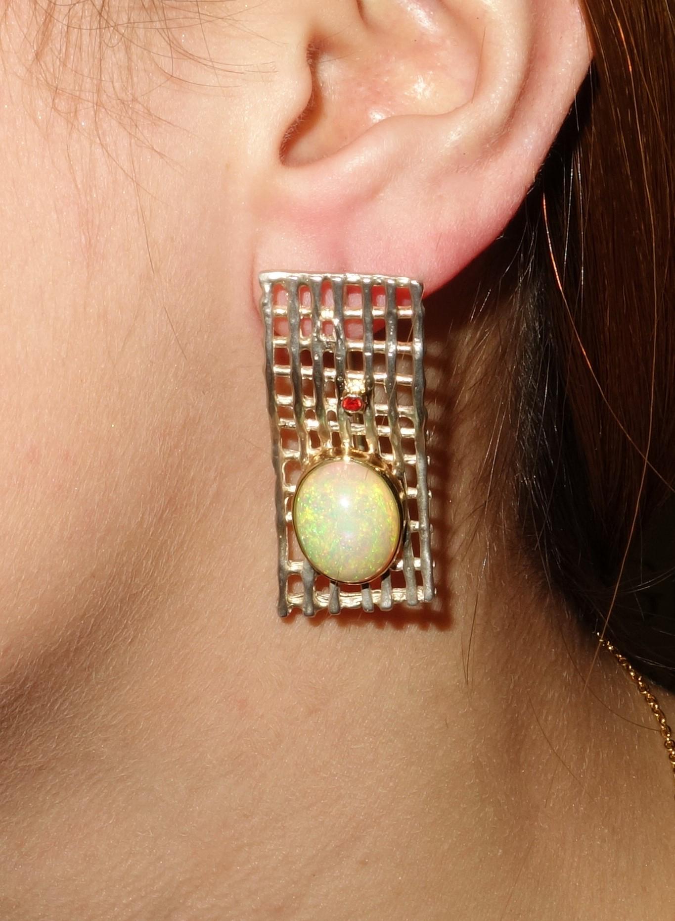Stylish and finely detailed Ethiopian Opal and Gemstone Sapphire Earrings in flattering Lattice design rectangular form. Hand crafted in Rhodium Tarnish resistant Sterling Silver with Gold accents; each earring is set with an Oval Ethiopian Opal,
