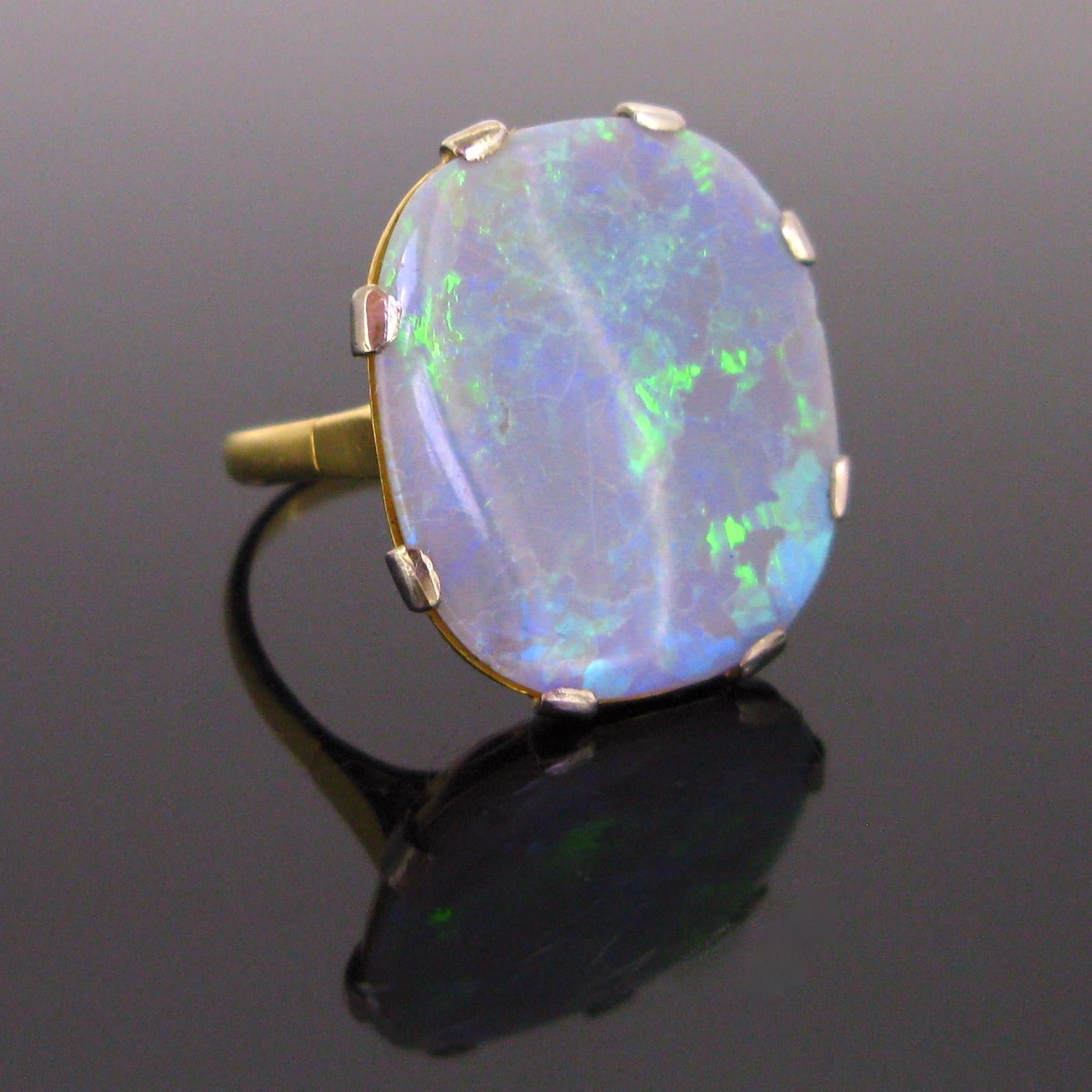 This important ring features an important oval cut opal which is set on platinum prongs. The ring is from the Sixties. The opal shows some beautiful fires in the blue and green colours. Opal is the birthstone for the month of October. “Opallios” is