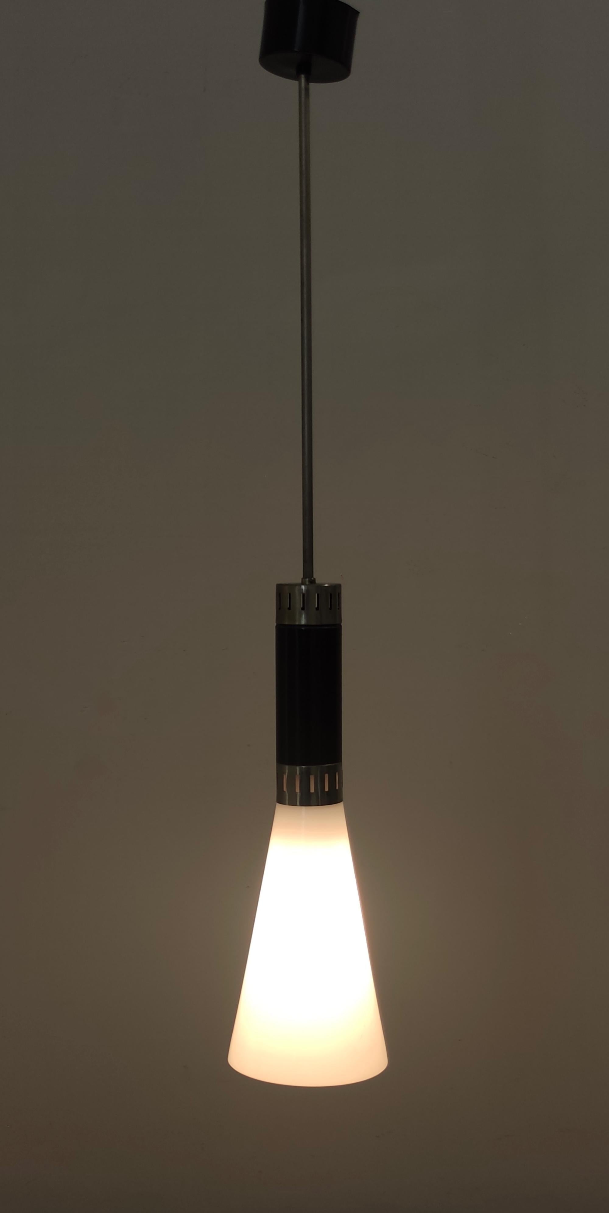 Made in Italy, 1960s.
It is in opaline glass, chrome plated brass and black varnished aluminum.
This pendant is a vintage item, therefore it might show slight traces of use, but it can be considered as in excellent original condition and ready to