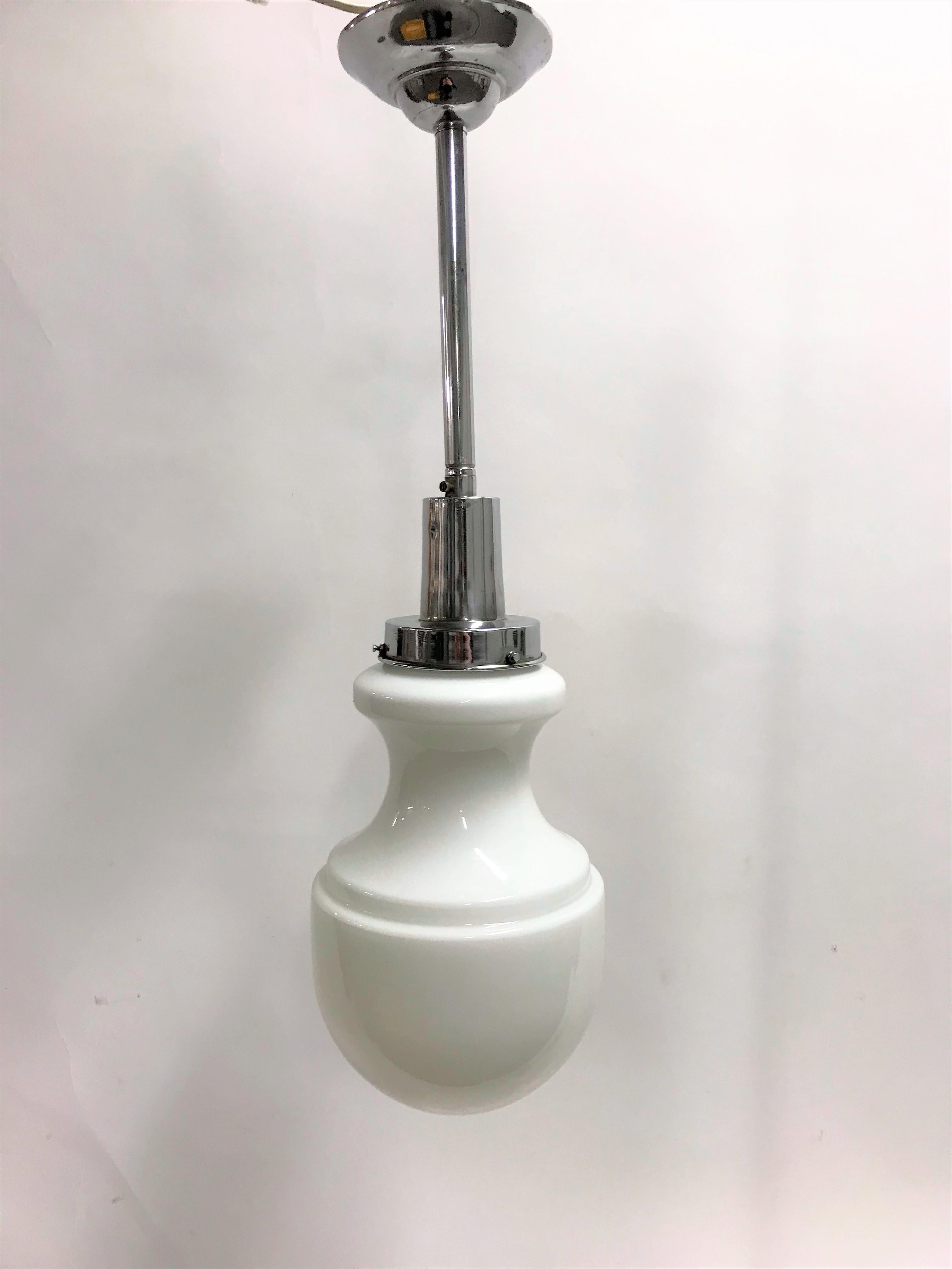 Unusual Art Deco pendant light made from opaline glass.

The light has a nickel plated shade holder.

It was used in larger homes with higher ceilings in the entrance halls or stairways. Sometimes these would be hung outside on the