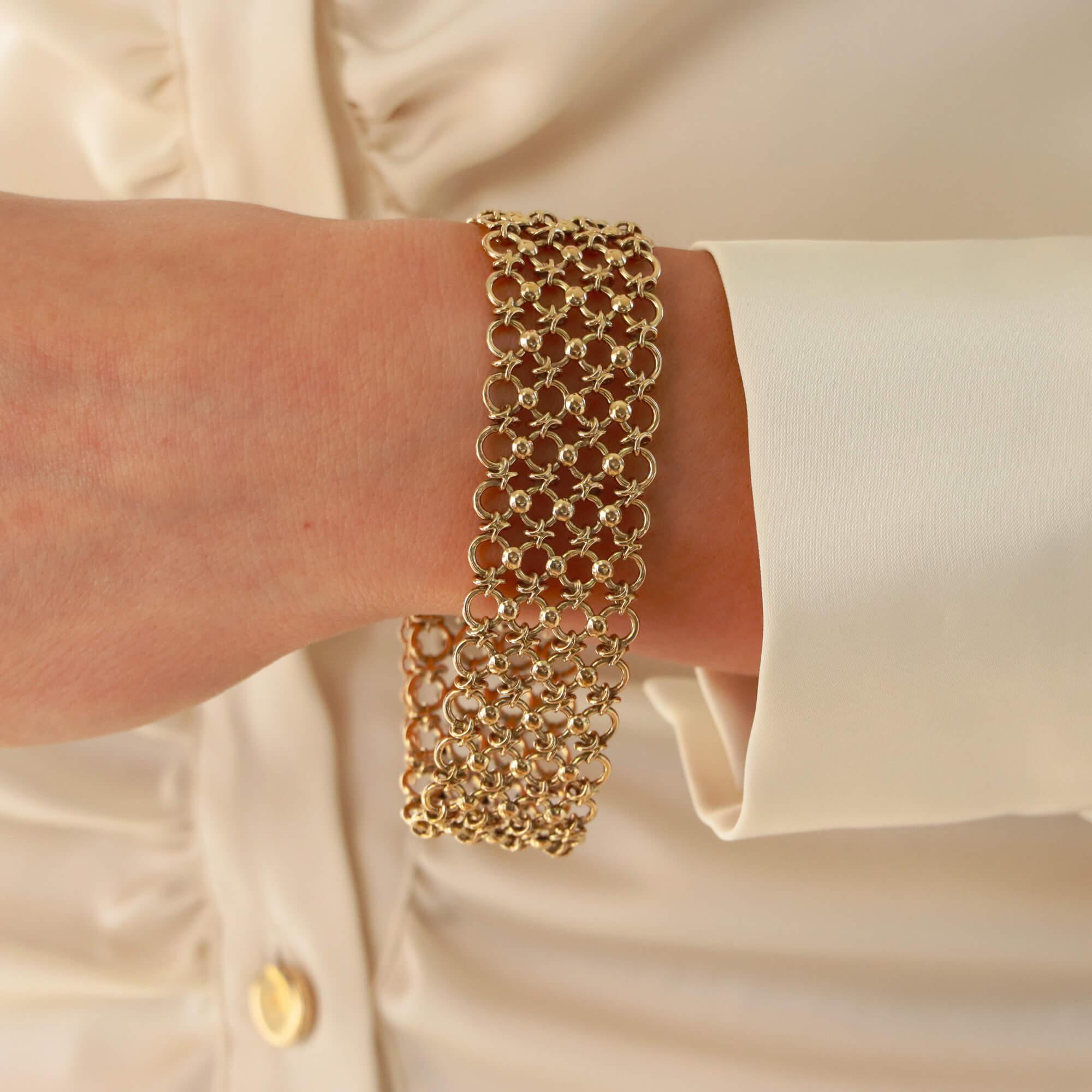 A beautiful vintage openwork bracelet set in 9k yellow gold.

The bracelet is composed of four rows of openwork gold which creates this beautiful looks once on the wrist! The bracelet is secured to reverse with a tongue push clasp and an additional