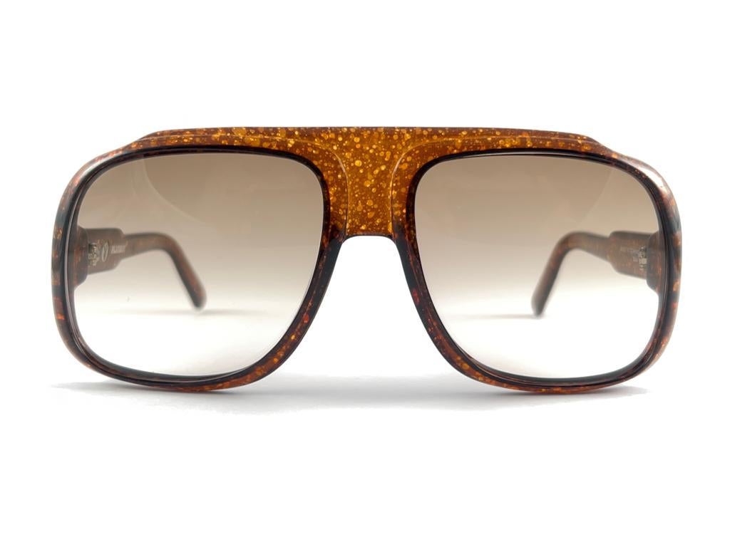 
Vintage Playboy Optyl Brown Marbled Frame Sporting Gradient Brown Lenses. 
 
Produced And Design In 1970'S.

This Item Show Minor Sign Of Wear Due To Storage.


Made In Germany




Frame Width                                             14.5