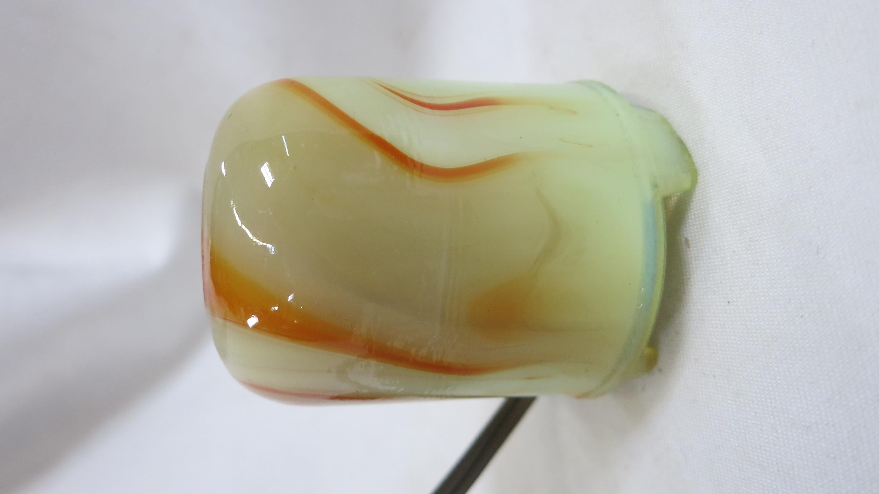 This two-piece lighter/ashtray was manufactured in the 1930s by Akro Agate Company, located in Akron, OH. This beautiful example is in excellent working condition and reflects a bygone era when smoking was considered glamorous. Akro Agate began
