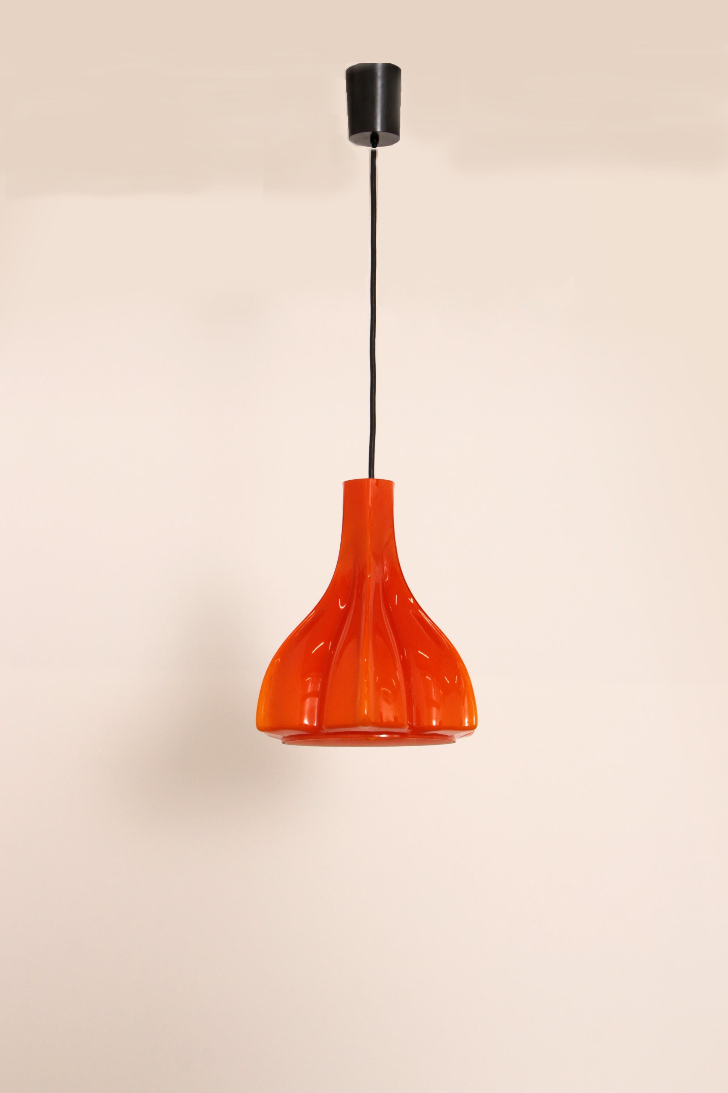 Particularly rare shaped orange glass hanging lamp by Peill and Putzler, produced around 1960 in Germany. Has a beautiful bright orange color and gives a very warm light.

Typical design of the German makers. More glass pendant lights in