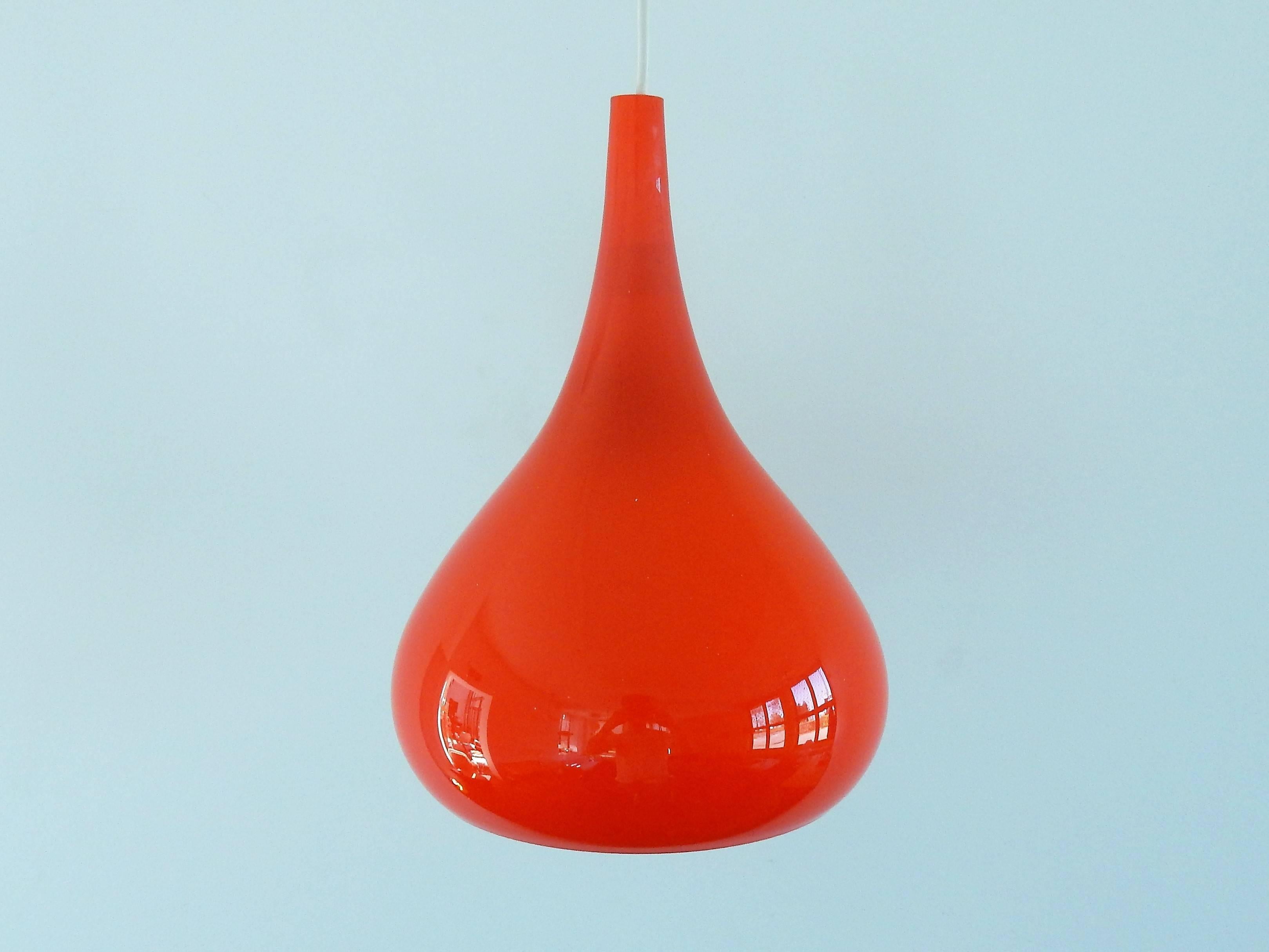 Very nice orange glass pendant lamp, imported from Denmark. The opaline inside gives a beautiful soft light. Could very well be Holmegaard. On the inside the lightbulb is hung to a cork that is marked 'made in Denmark'. The lamp is in a very good