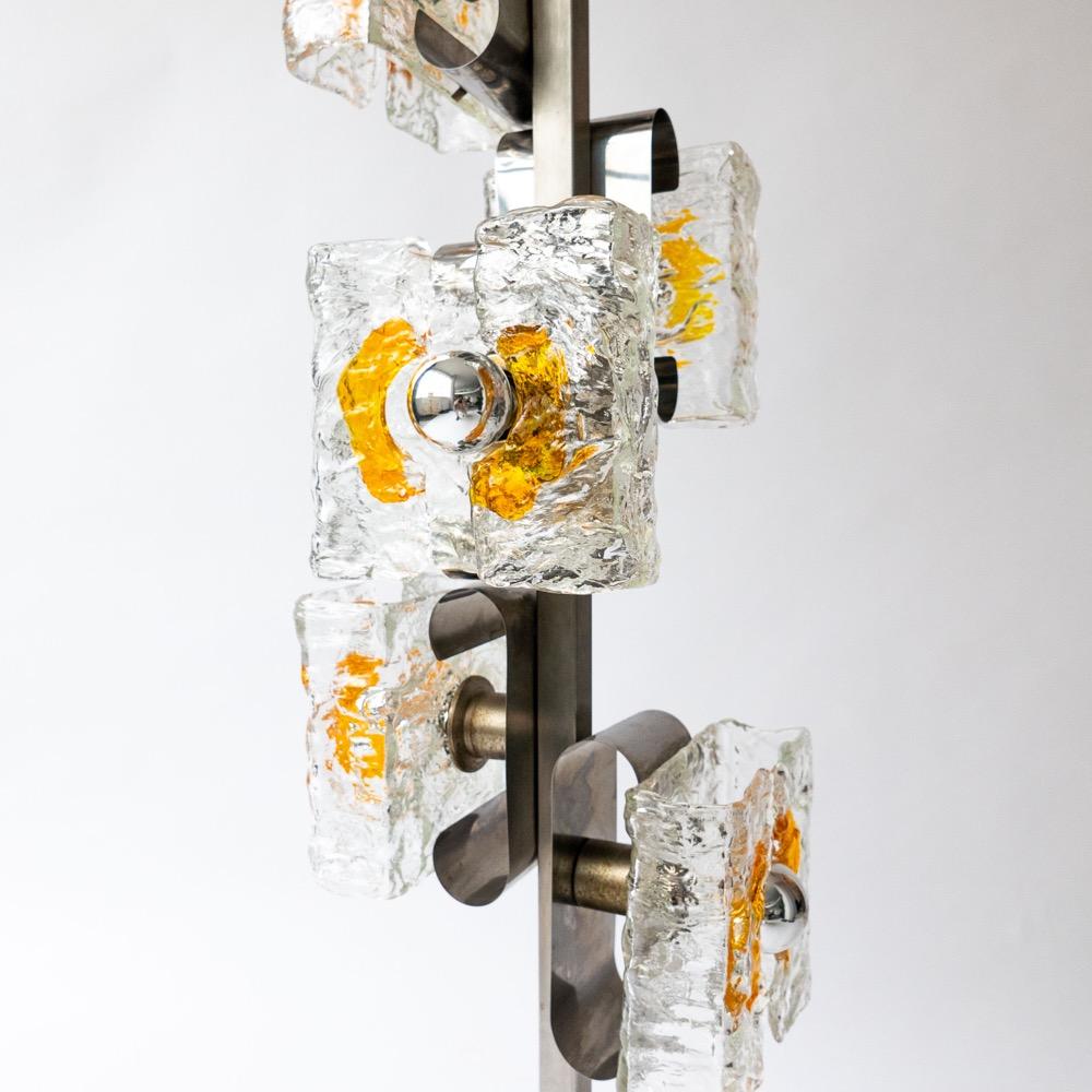 Plutôt courantes dans les années 60, les lampes en métal chromé et en verre de Murano se font aujourd'hui de plus en plus rares. Le présent exemplaire, conservé dans de parfaites conditions et caractérisé par ses nuances de lumière épaisses et Mater