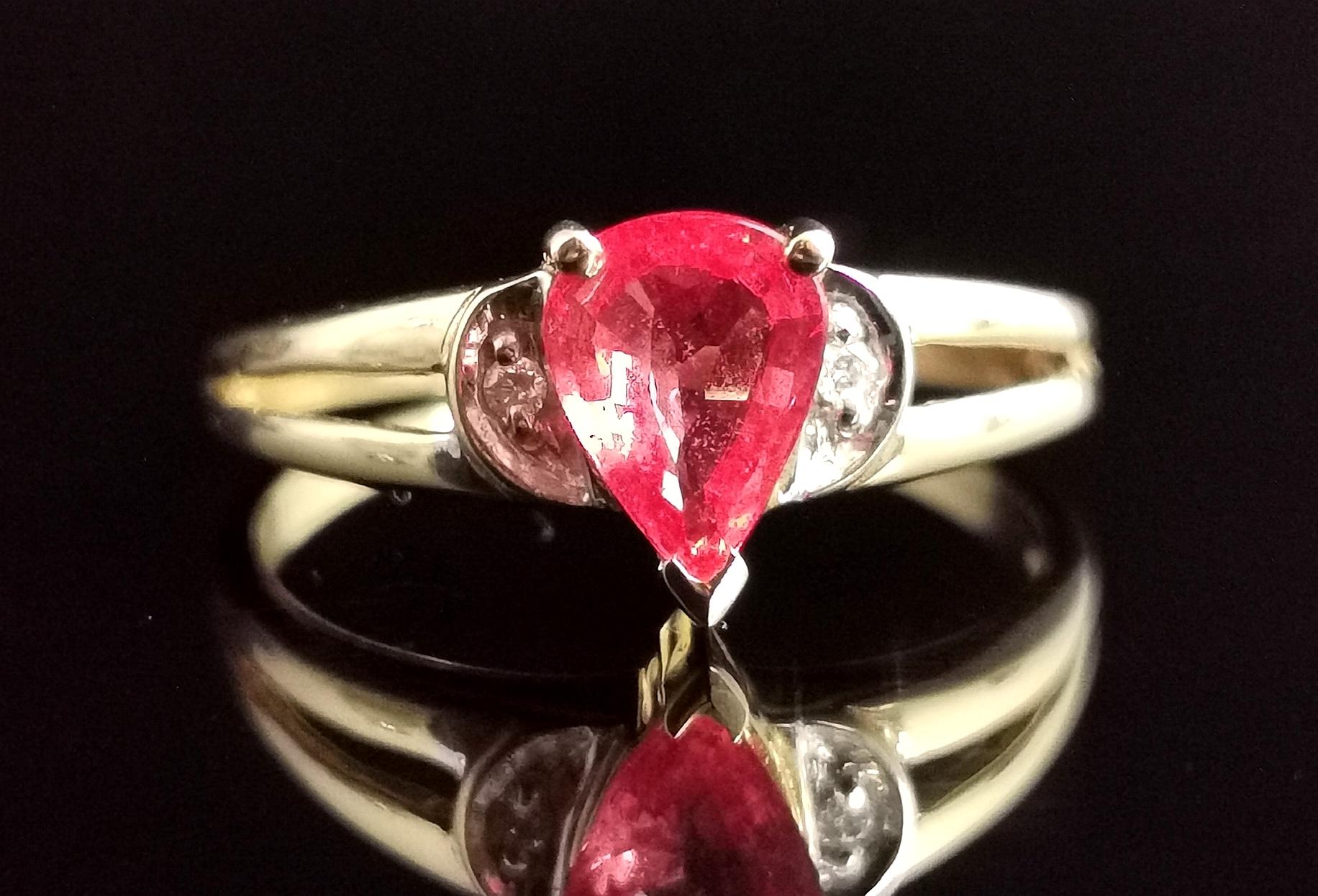 A Gorgeous vintage Orange Sapphire and Diamond ring in 18ct yellow gold.

It features a central trillion cut orange sapphire with reddish tones, similar to a blood orange colour with an approx carat weight of 0.98ct.

It has crisp white diamond