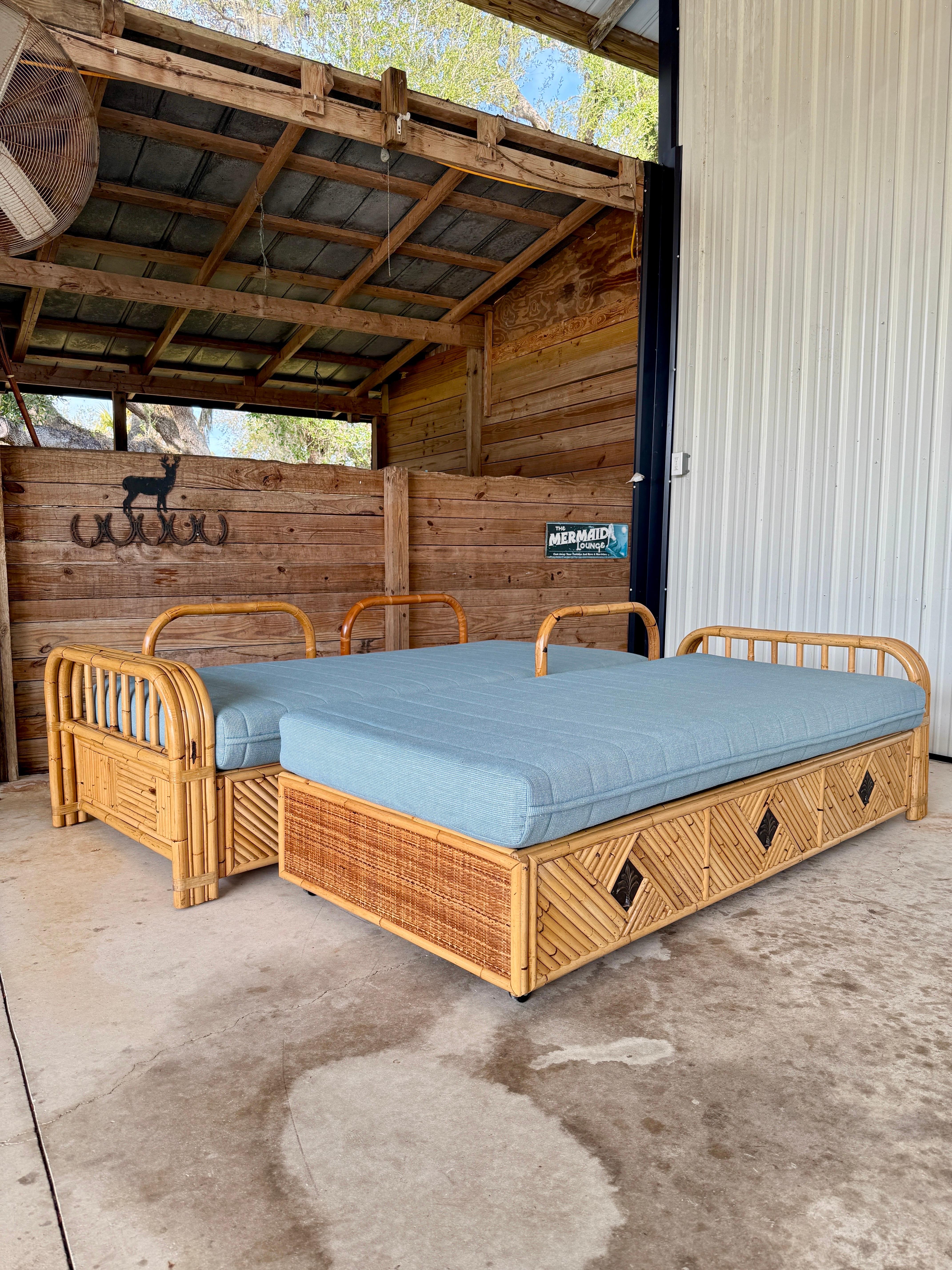Versatile and stylish, this pair of vintage bamboo rattan daybeds doubles beautifully as sofas, offering both functionality and undeniable charm. Each piece features built-in storage compartments beneath the seat, providing a practical solution for