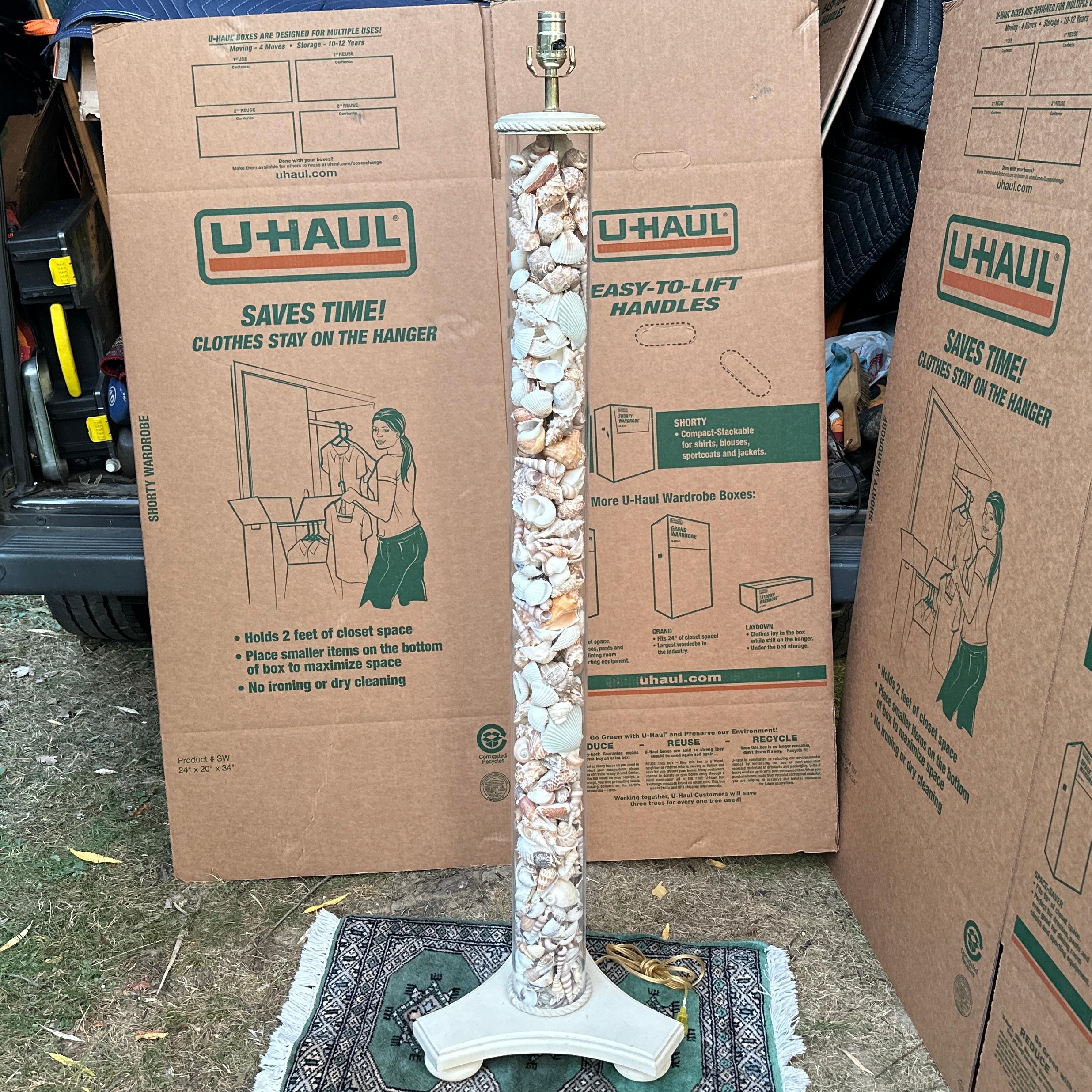 Vintage acrylic floor lamp on whitewashed wood base with bun feet. The lucite section is completely filled with hundreds of beautiful natural shells, from sand dollars to seahorses. Great beach-y style to bring some 