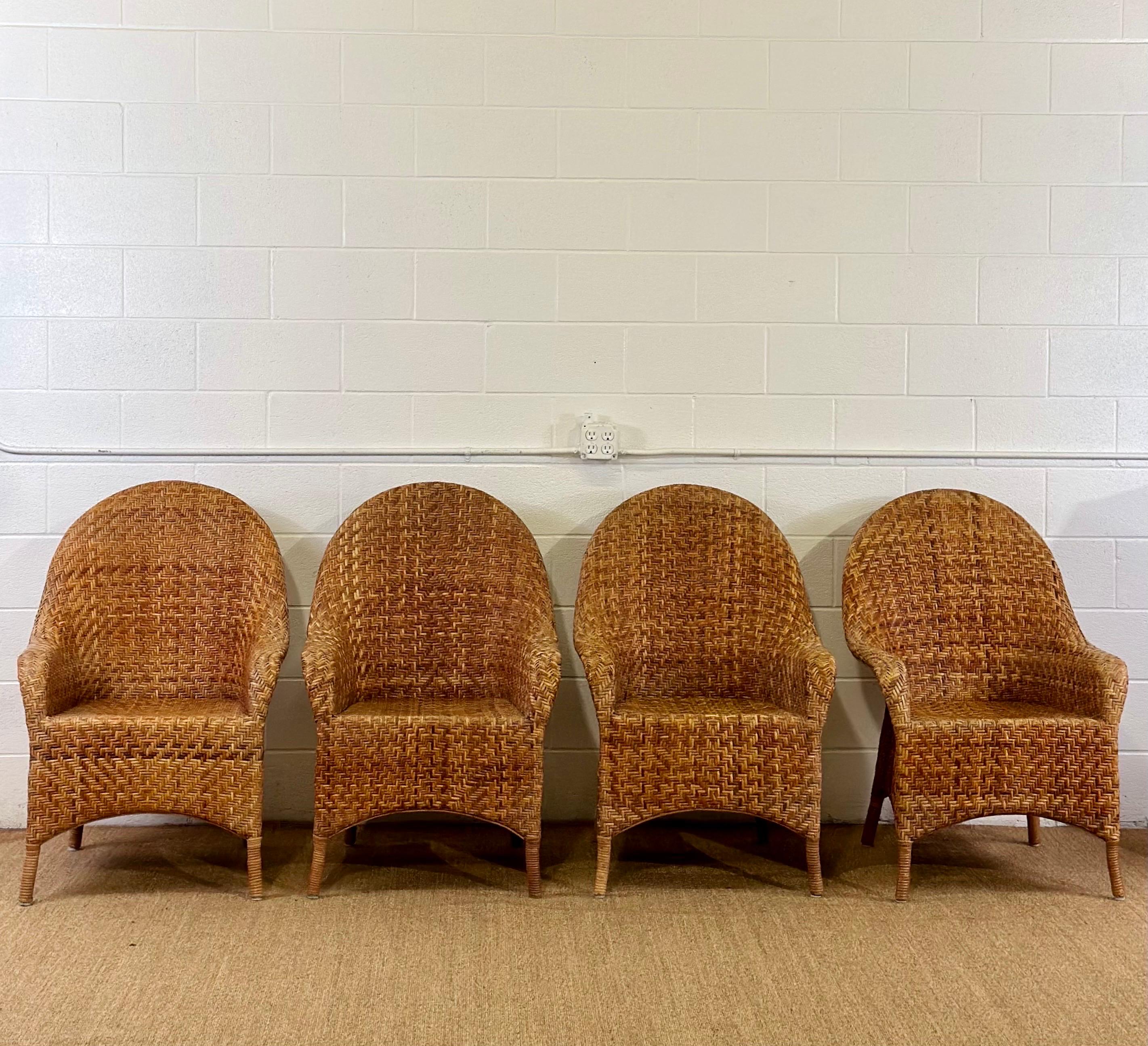 We are very pleased to offer a vintage set of four armchairs, circa the 1980s.  This set features an exquisite bamboo frame, artfully bent to provide both structural support and a graceful, inviting curvature.  The bamboo construction not only
