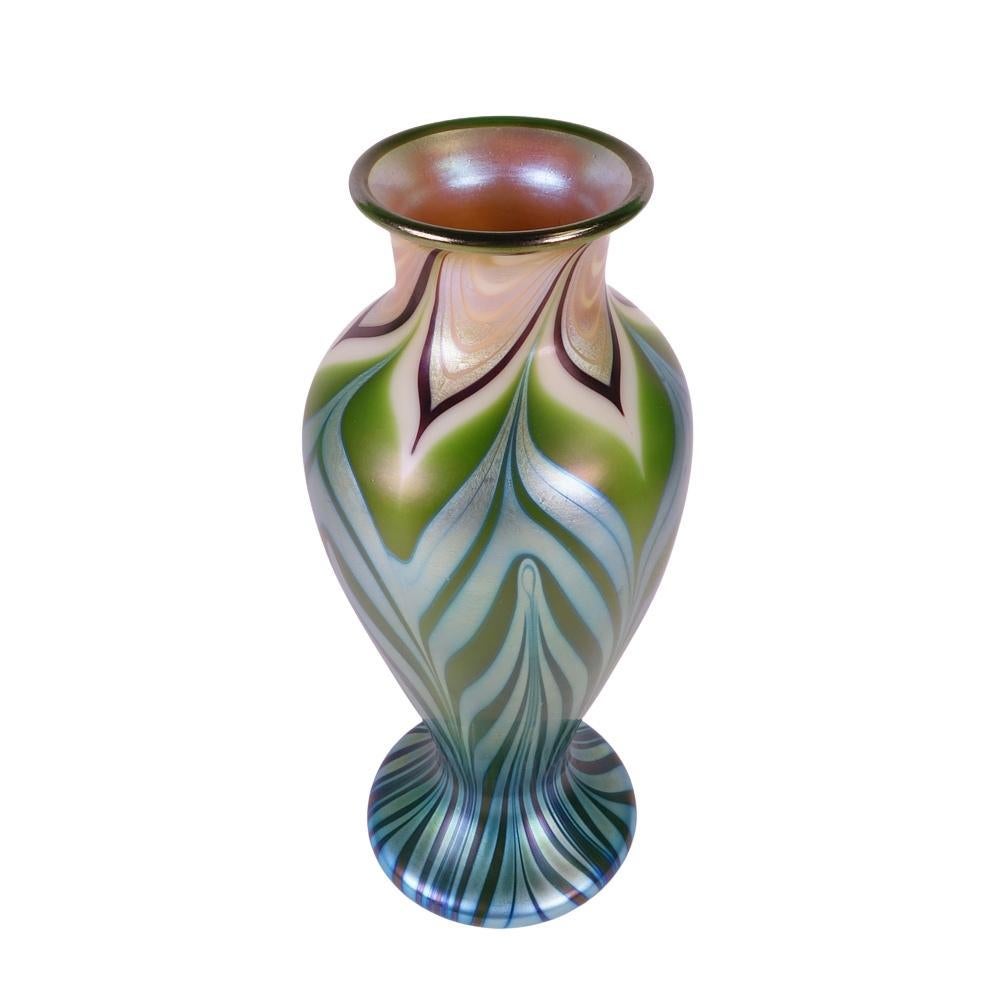 Presenting this outstanding Orient & Flume art glass vase. Vase is decorated with combed and pulled feather design. The main colors of this vase are jade green with iridescent opal, gold and platinum, very Tiffanyesque. This vase is in excellent