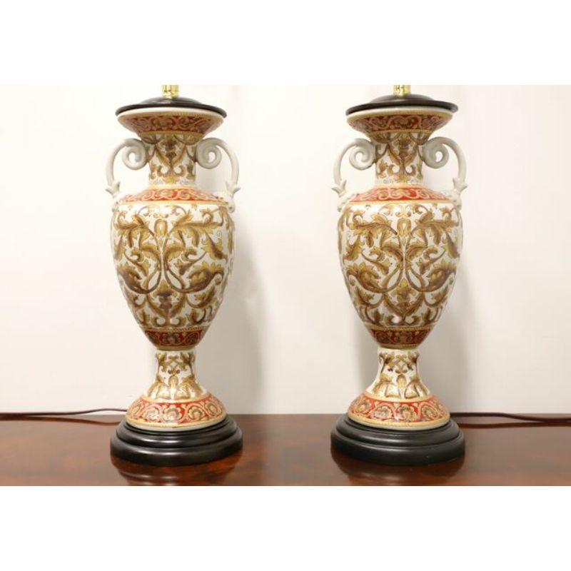 A pair of Oriental table lamps by Oriental Accent. Made of porcelain in an urn style on a brown resin base with brown resin cap to urn. Has metal harps and finials. Single standard bulb socket and 3-way rotary switch. Made in China in the mid - late