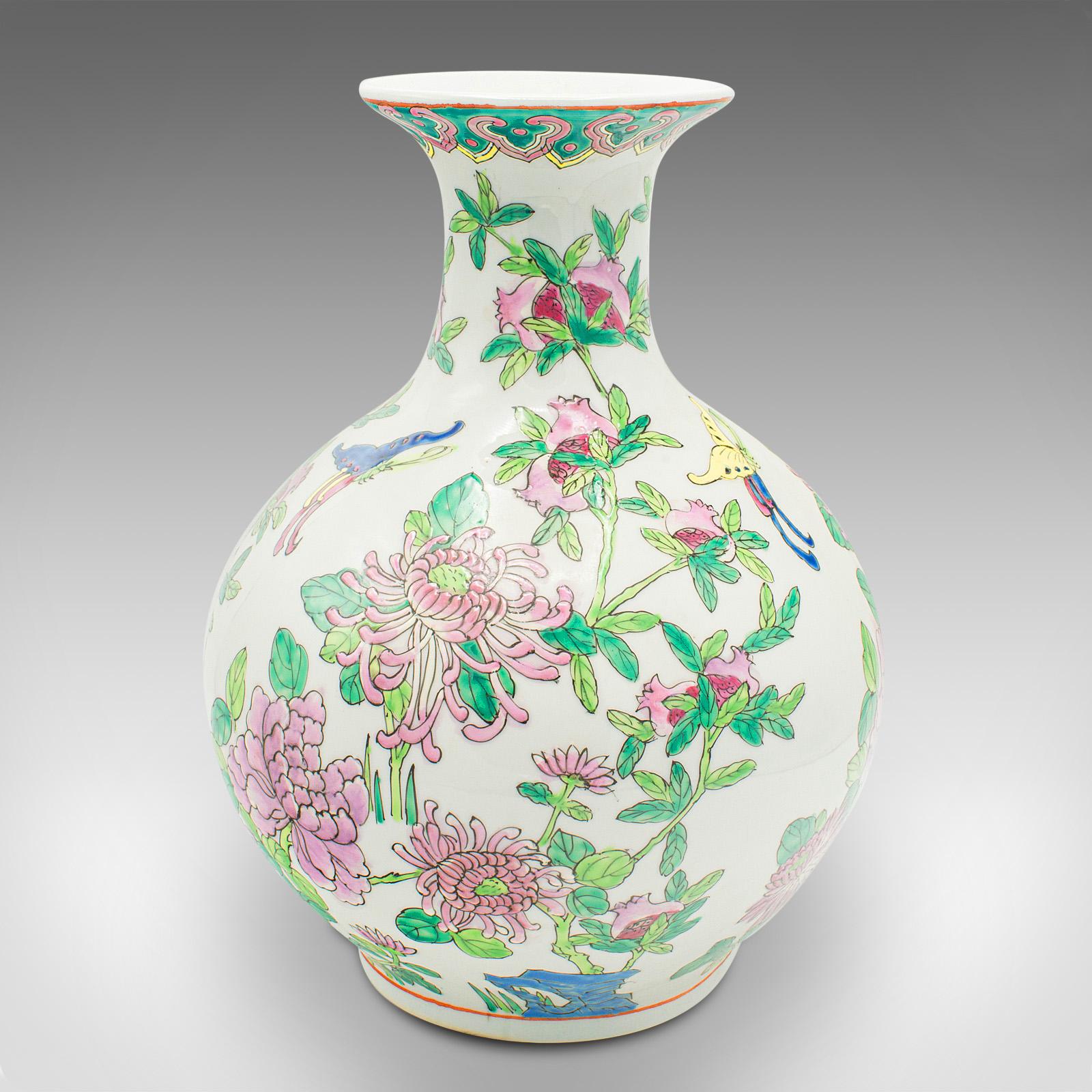 This is a vintage Oriental baluster vase. A Chinese, ceramic flower urn with polychrome enamel finish, dating to the late Art Deco period, circa 1940.

Superb dragon decor with a cast of charming figures
Displaying a desirable aged patina and in