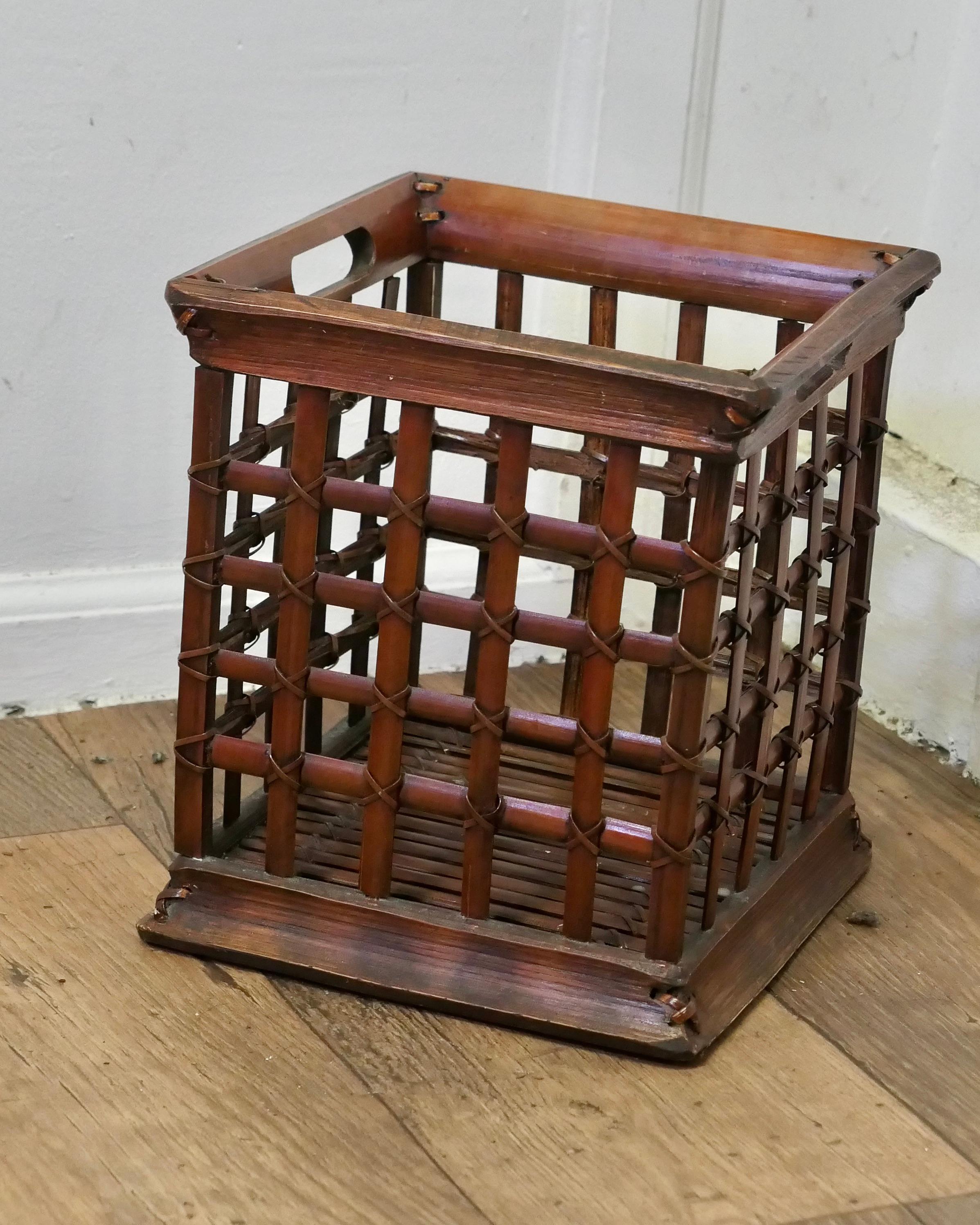 Vintage Oriental Bamboo Waste Paper Basket

A very attractive piece, unusually it is in a cube shaped the bamboo is woven in squares and is tied at the joints, all in very good condition, it is 11” high and 10” square 
FB50
