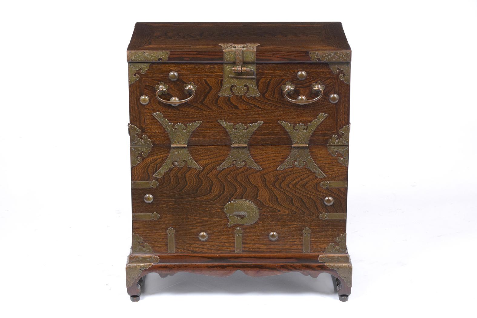 This vintage Korean chest with decorative brass accents is made out of solid wood and has been newly restored, this piece is finished in walnut color only been waxed/polished bringing amazing patina finish. This piece has a finely brass engraving
