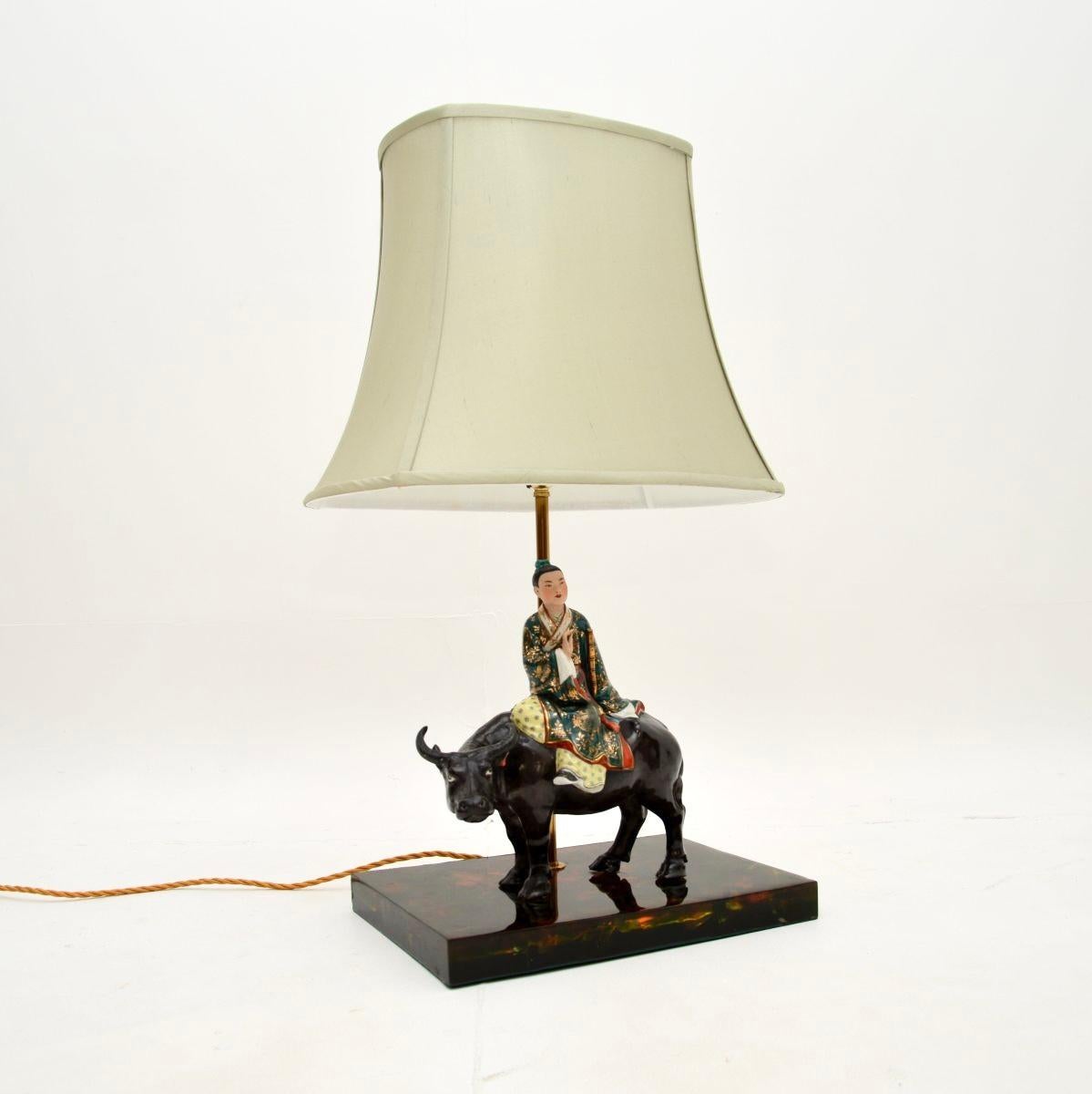 A wonderful vintage Oriental ceramic table lamp, dating from the 1960’s.

It is of excellent quality and depicts a lovely subject of a boy riding a bull. It is full of character and charm, and it is an impressive size.

This is in great overall