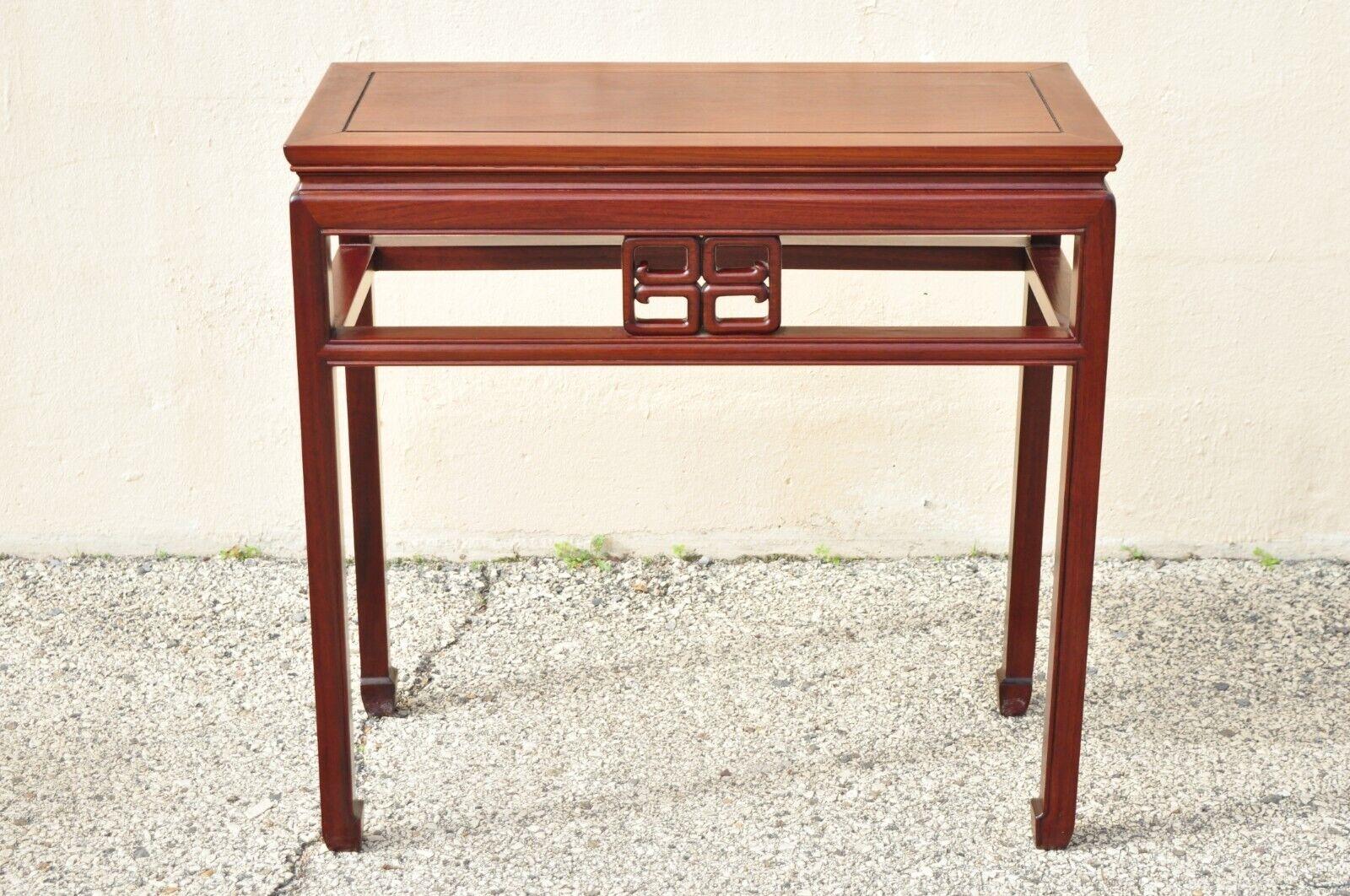 Vintage Oriental Chinese carved hardwood console side table with carved skirt. Item features carved fretwork skirt on both sides, carved hardwood frame, very nice vintage item, clean modernist lines, great style and form. Circa mid to late 20th
