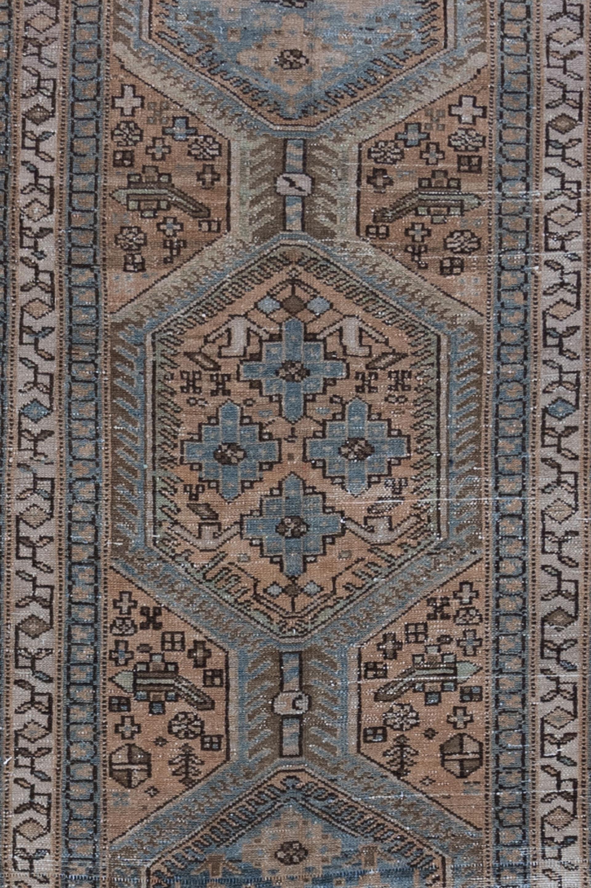 Age: Circa 1930

Colors: adobe, pink brown, blue, gray-teal, gray-brown, ivory

Pile: low

Wear Notes: 4-5

Material: wool on cotton

Vintage Persian runner in a beautiful color scheme of warm but faded earthy tones and a contrasting blue.