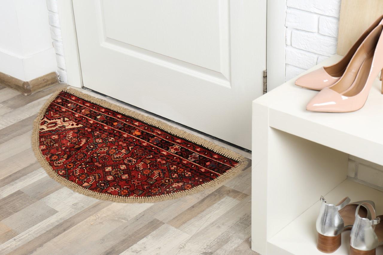 This semicircle entranceway doormat has been refurbished from a handmade vintage carpet rug- cut from large area rugs to create these small doormats, with handwoven fringe detail. Handspun cotton and wool have been used in the construction of these