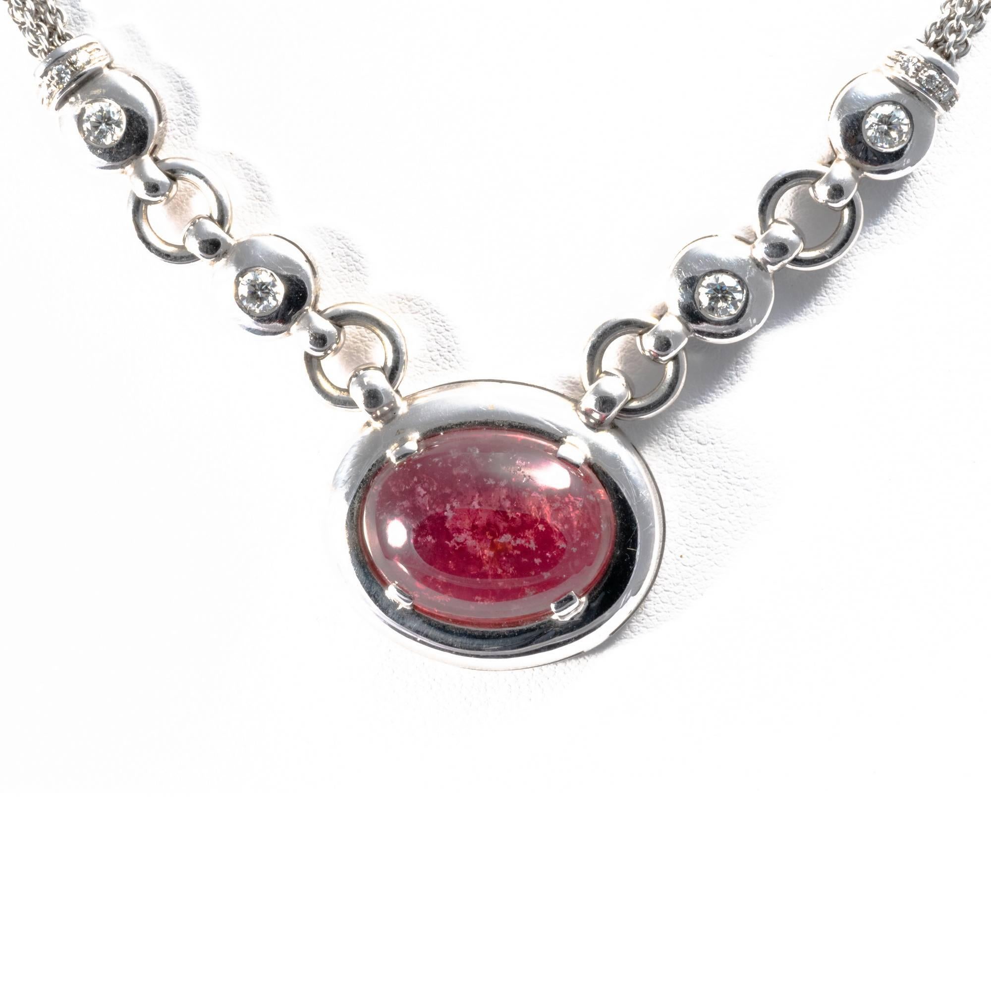 Bold and lavish, this vintage necklace is a true symbol of the 1980's best style. This stunning necklace  shows at the centre a  vivid red tourmaline set in a large round bazel,  a real eye-catcher thanks to it's generous proportions. The same