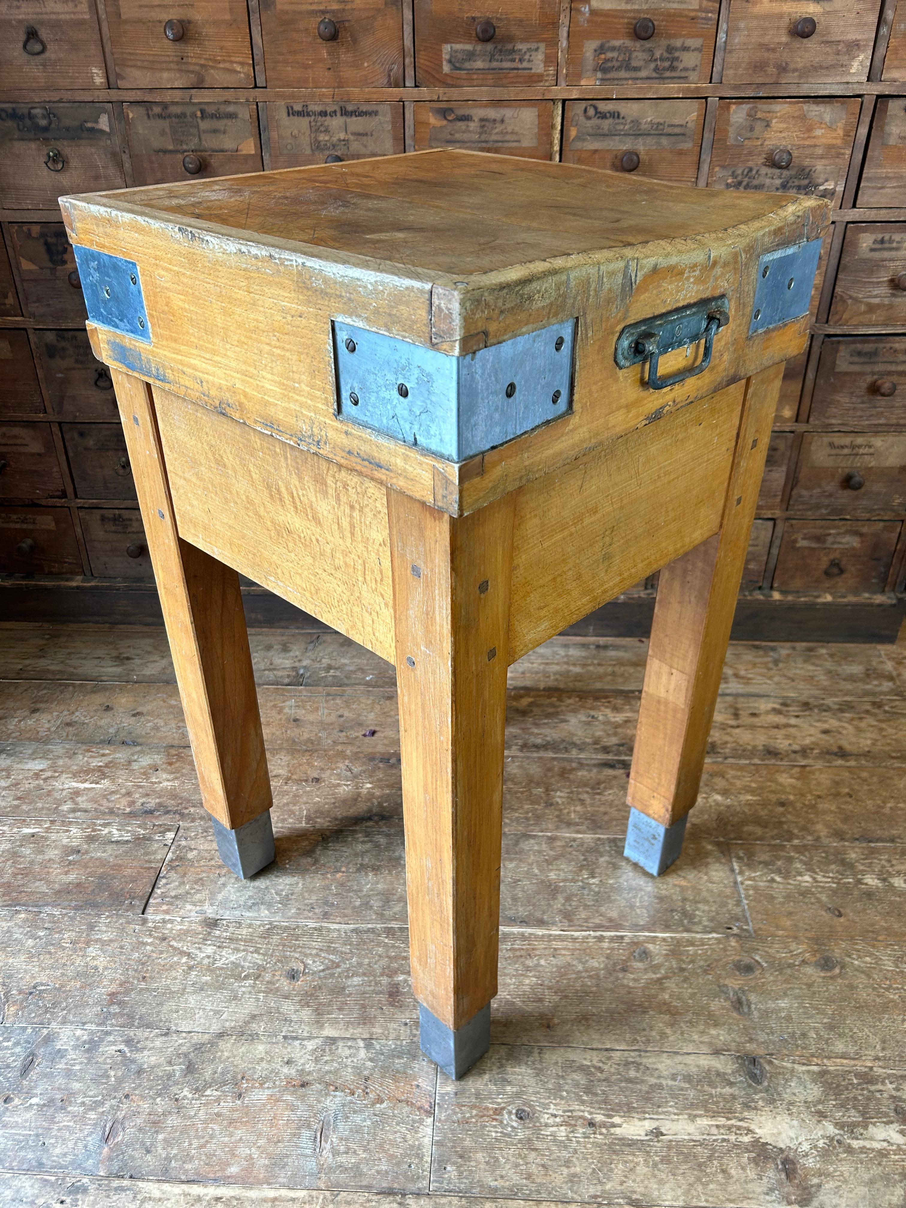 An original English vintage beech butchers block table made in the 1950’s. The block consists of two parts which come apart if required. The top has been constructed with end grained blocks of beech and a side grain perimeter.  The sides have 4