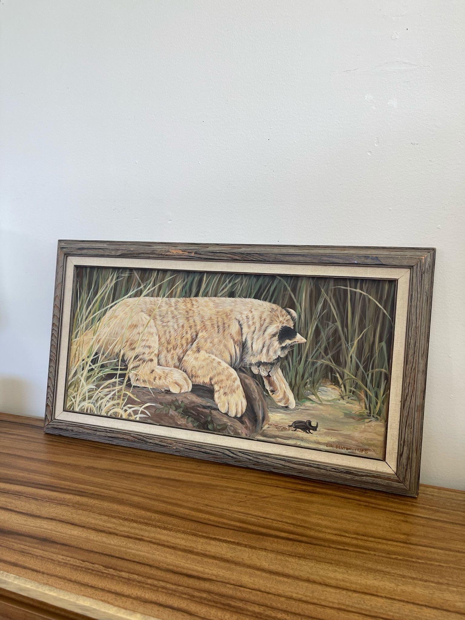 This Painting showcases a Lion Cub playing with a small beetle. Professionally framed and matted, signed in the Lower Corner. Lilly mixed Media. Possibly Oil. Information on the painter on the back of the painting as pictured. Vintage Condition