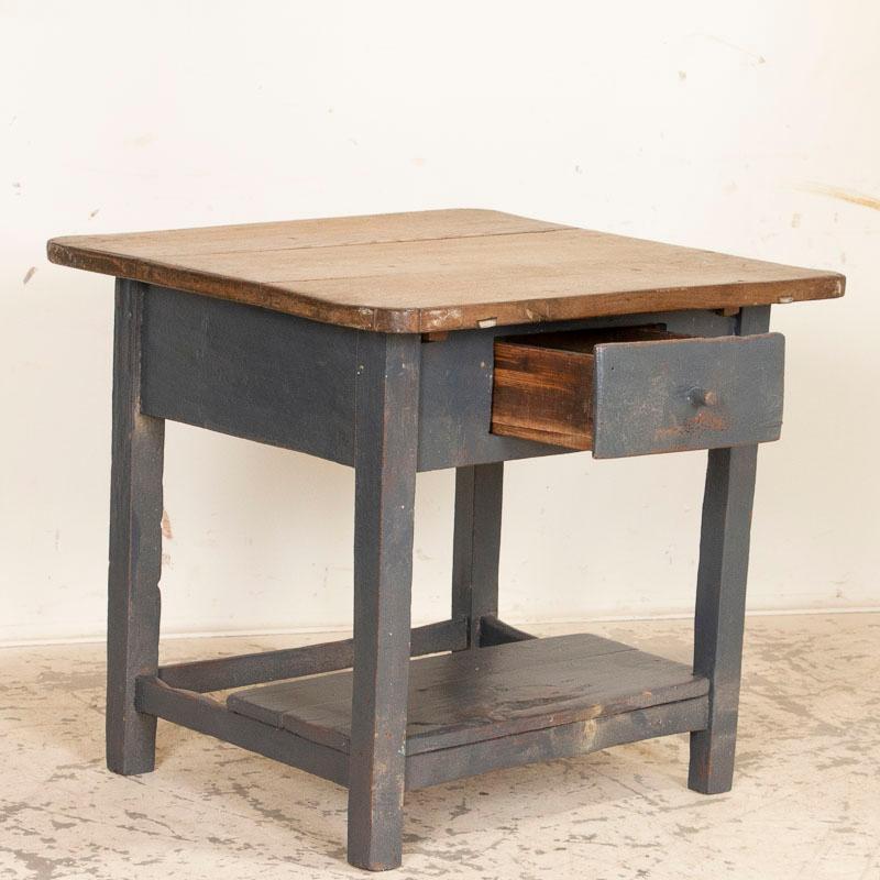 The deep, bluish gray paint on this side table is all original, but look closely at the detailed photos to appreciate the layers and variations to the color which add character to this small table. The top has been left natural, made from 3 strong