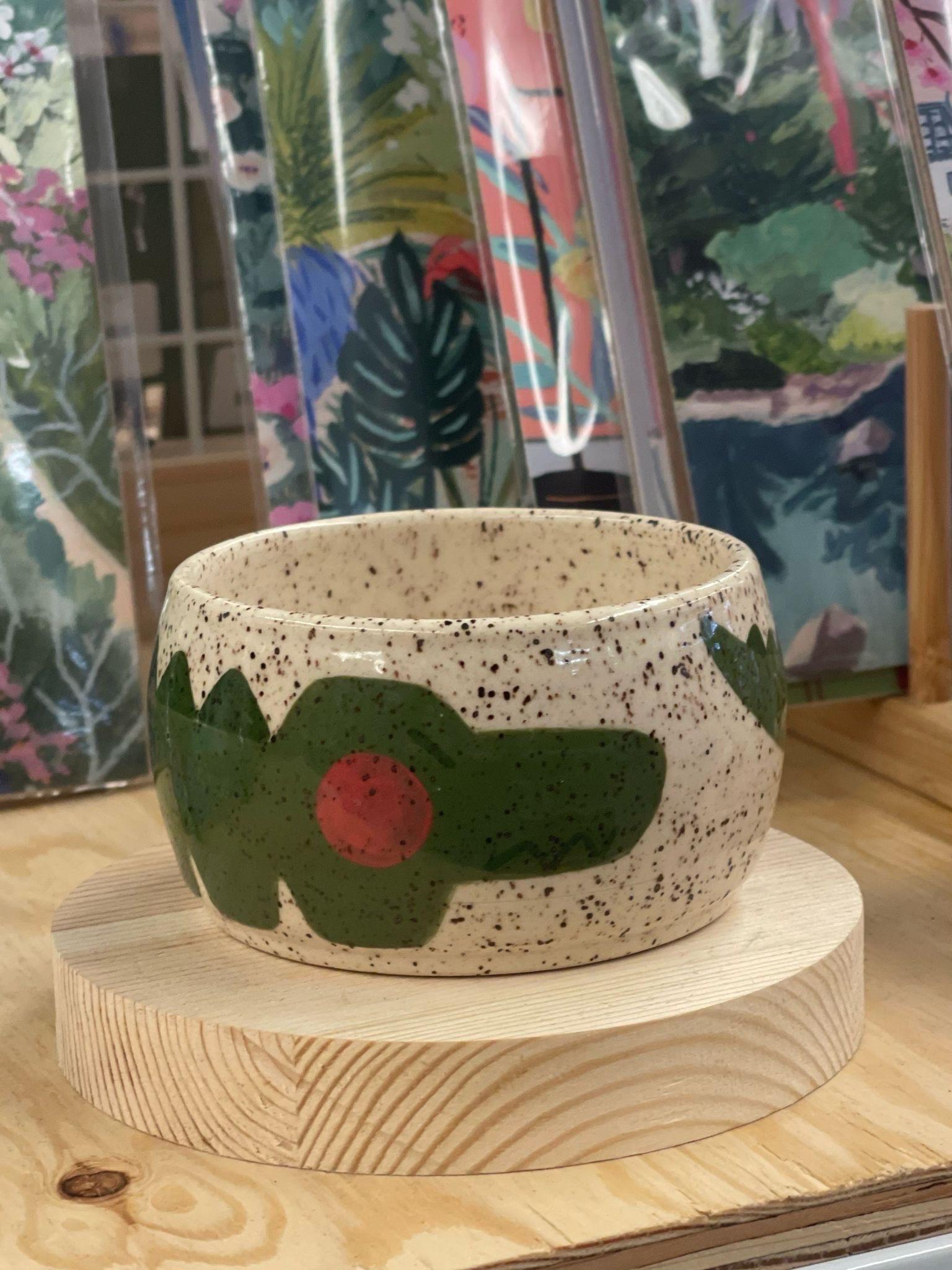 This speckled Bowl has an adorable cartoon alligator wrapped around the sides. Makers mark on the bottom. Little Oakie Studios is a Seattle based company specializing in Kawaii inspired Design. Every piece is Handmade, with slight variations natural