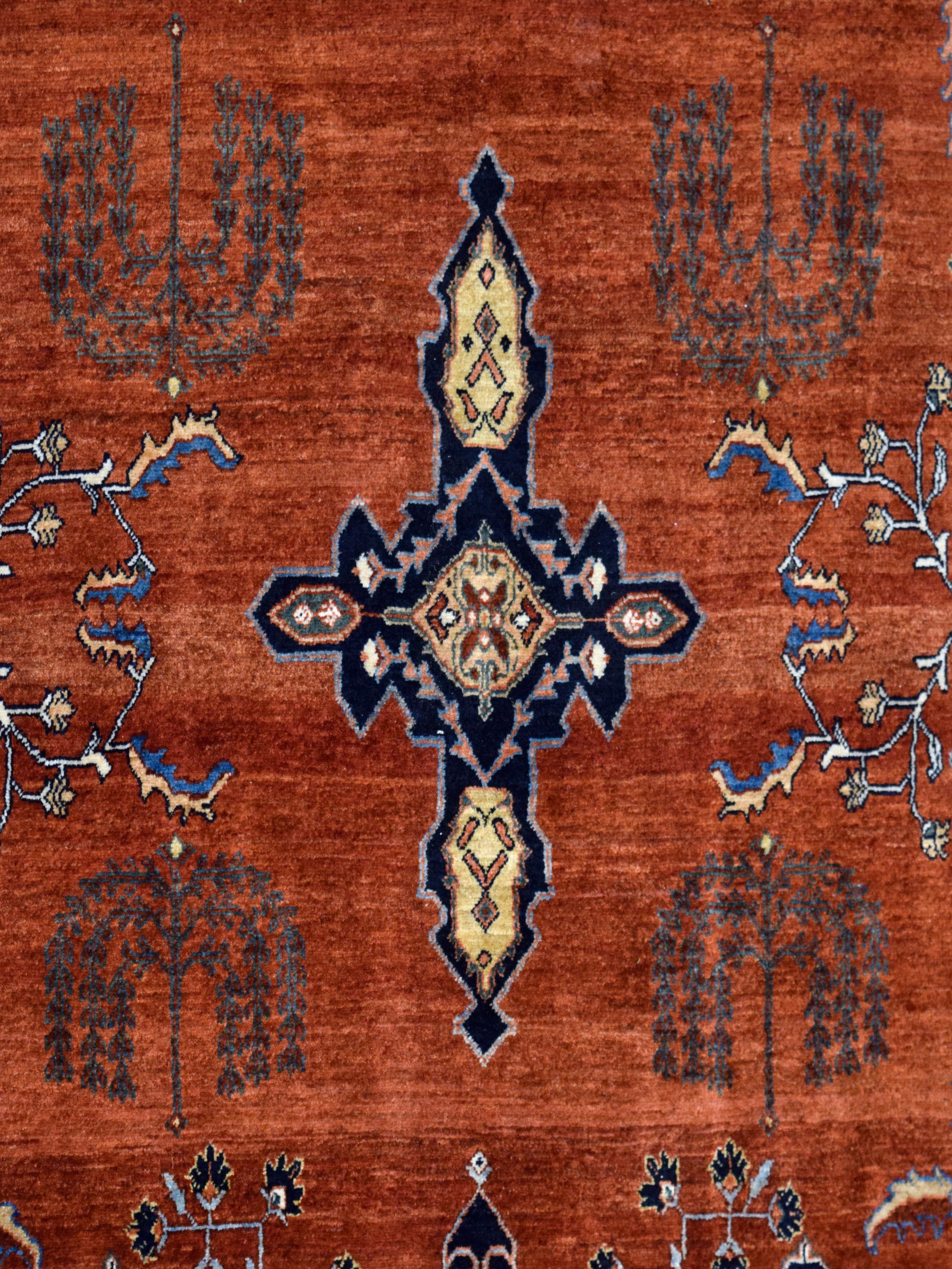 With deep and robust shades of red, indigo, green, and gold wool, this hand-knotted Mohajeran carpet measures 8’8” x 13’ and is a true homage to classic Persian rugs. Stemming from the Sarouk family of carpets, Mohajerani carpets are the rarest