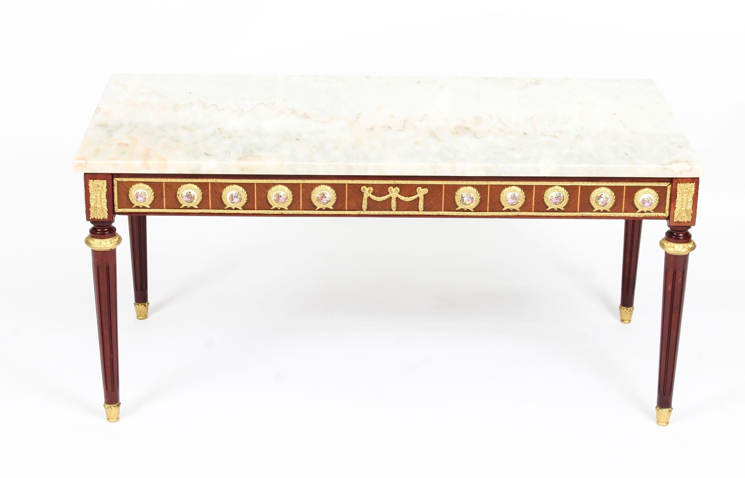 This is an exquisite ormolu-mounted walnut and kingwood marble top coffee table, circa 1950 in date and by the renowned furniture makers H & L Epstein.

This wonderful coffee table is rectangular in shape and has four elegant and stylish tapering
