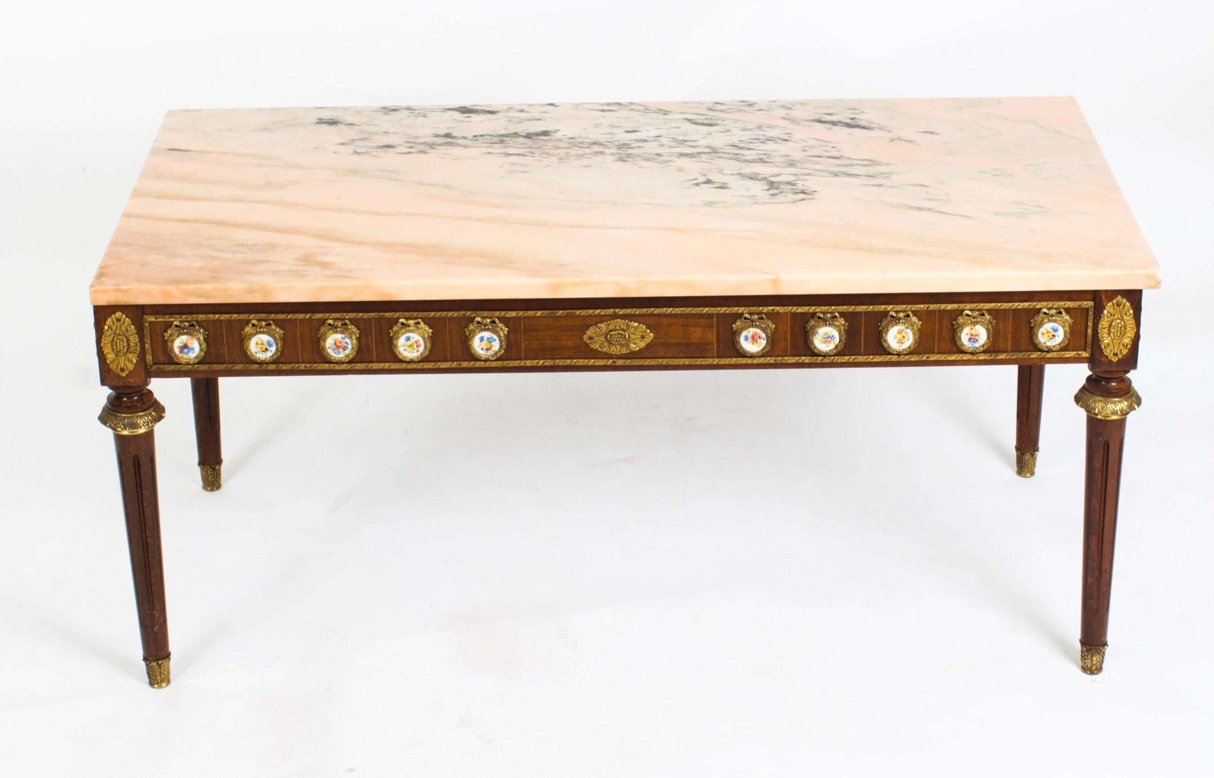 This is an exquisite ormolu-mounted walnut and marble top coffee table, circa 1950 in date and by the renowned furniture makers H & L Epstein.

This wonderful coffee table is rectangular in shape and has four elegant and stylish tapering fluted