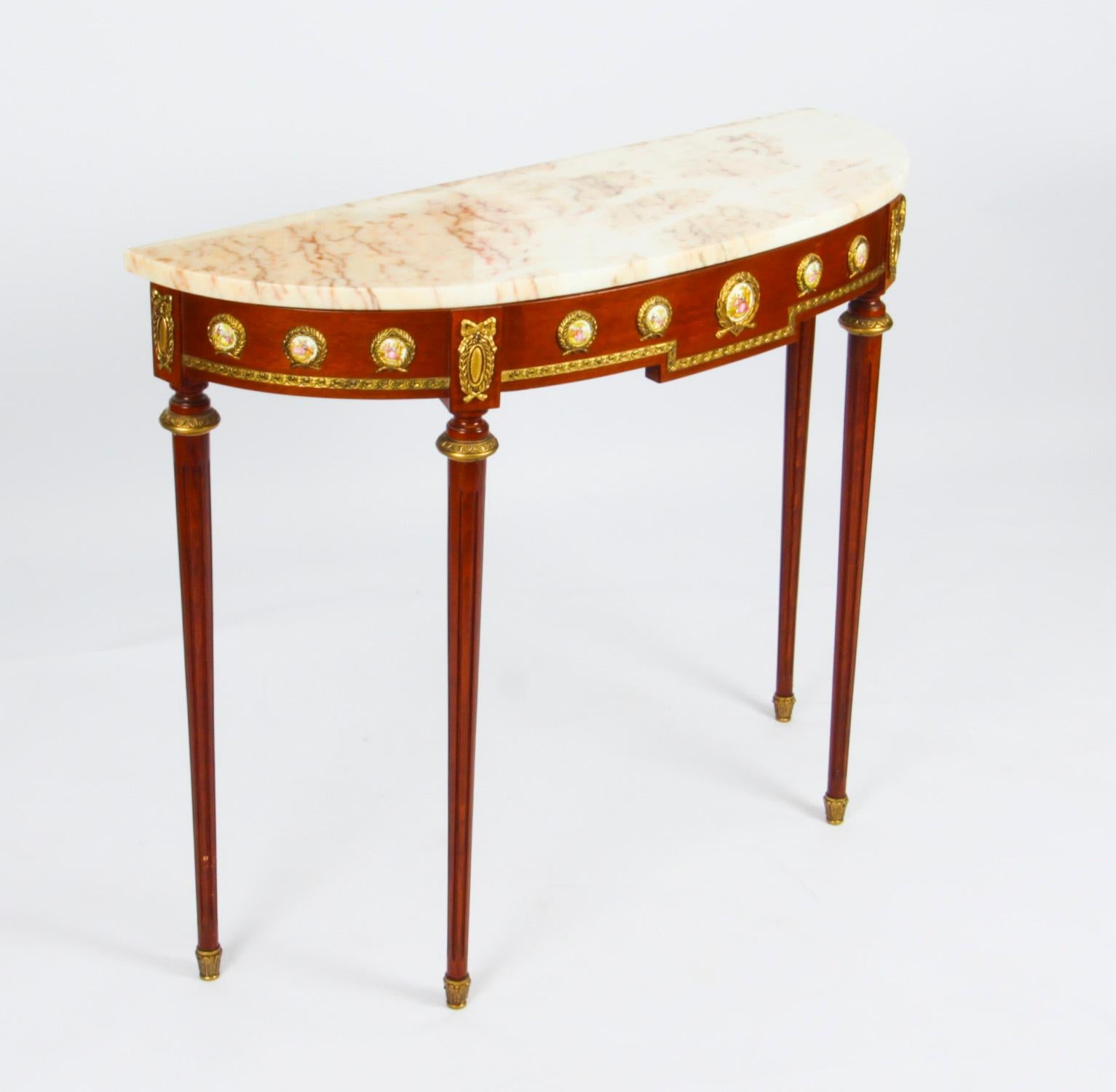 This is an elegant Louis Revival console table and mirror by the renowned cabinet maker H & L Epstein, dating from mid 20th century.

These magnificent pieces are crafted from wood with stunnning ormolu mounts and the console features ten Sevres
