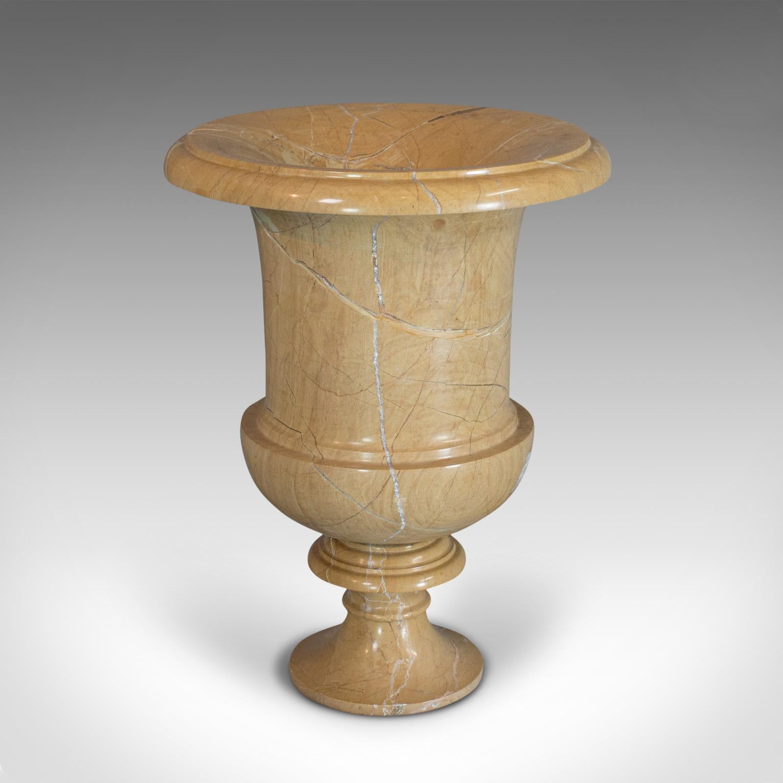 This is a vintage ornamental baluster urn. An English, golden pearl marble decorative vase, dating to the late 20th century.

Classical appeal with golden hues
Displays a desirable aged patina
Shapely baluster urn with marble interest

Mouth