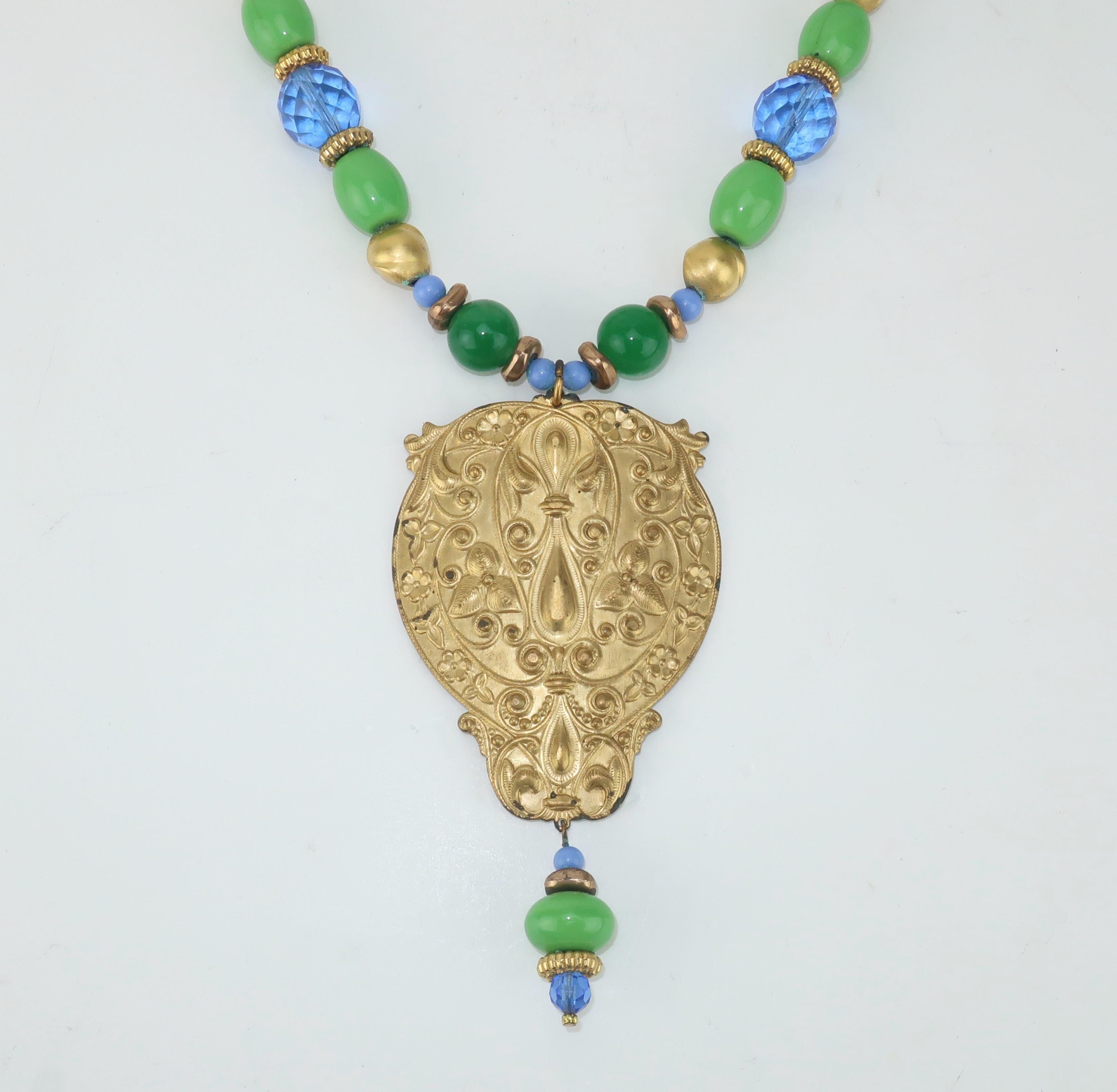Vintage blue and green glass bead necklace with an ornate gilt metal medallion pendant.  The screw on ball closure ensures a secure fit.  No hallmark present though beautifully made with quality details.
CONDITION
Beautiful at first glance though